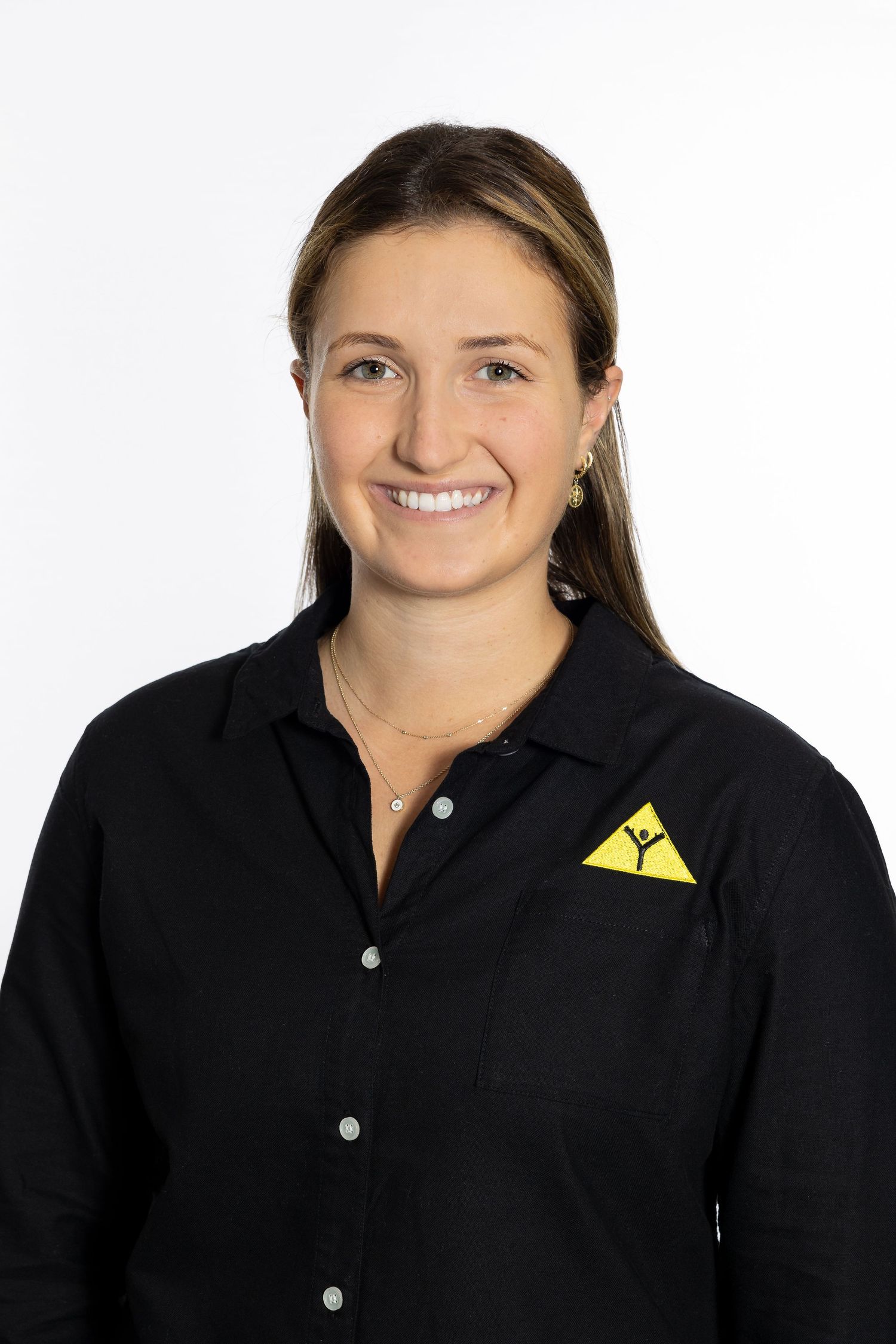 Professional headshot of staff member wearing black button-up shirt with yellow logo.