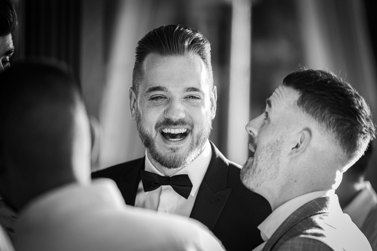Sydney Event Photography - Black and white photo capturing joyful laughter at formal event.