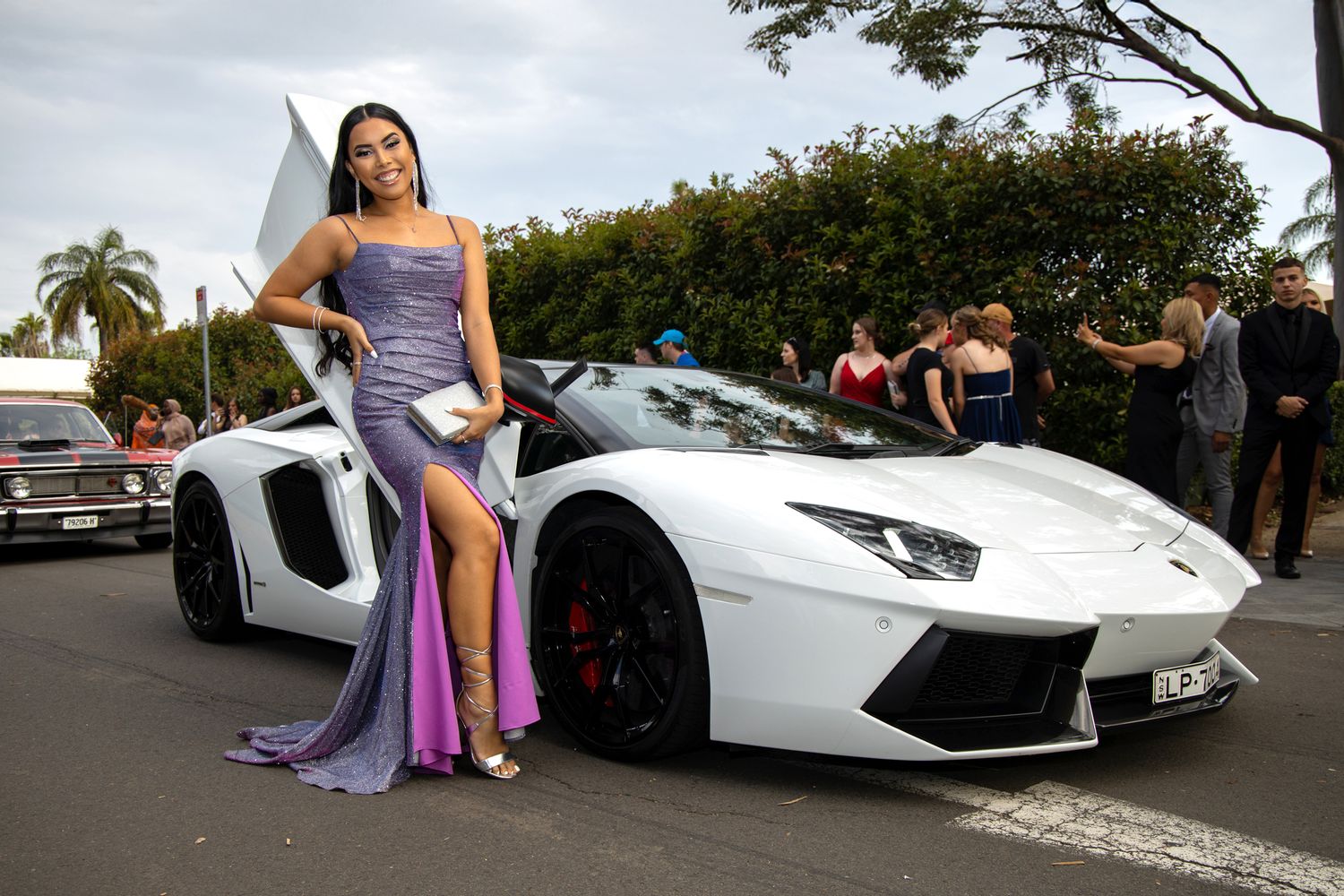 Sydney Event Photography - A white Lamborghini Aventador parked outdoors with an elegant purple dress in the foreground.