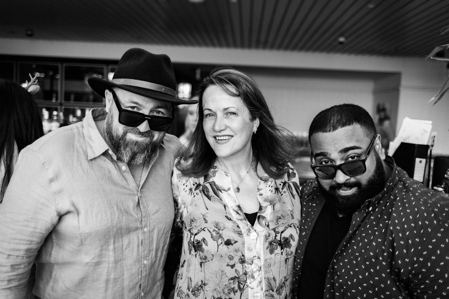 Sydney Event Photography - Three friends pose together at a social gathering, with two wearing sunglasses.