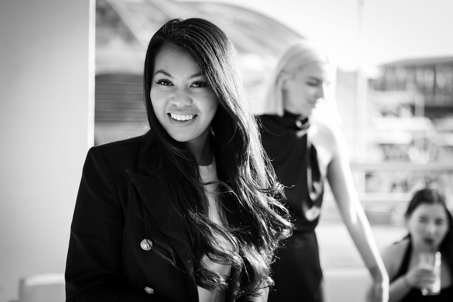 Sydney Event Photography - Black and white portrait showing bright smile against light background.
