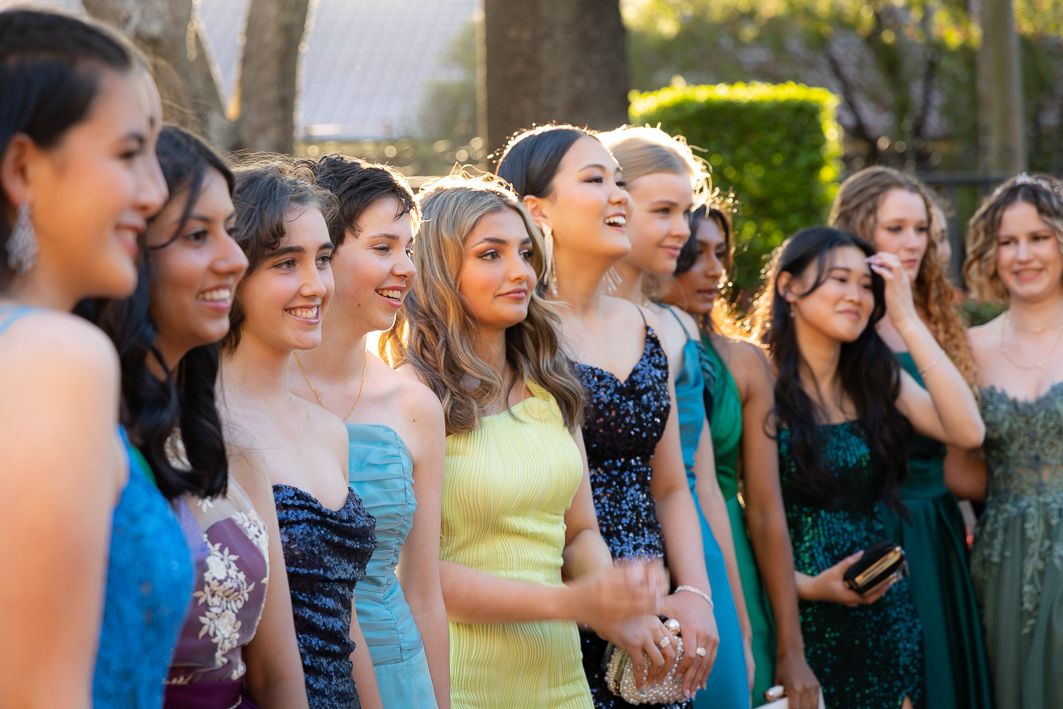 Sydney Event Photography - A group of friends in colorful formal dresses gather outdoors during a special event.