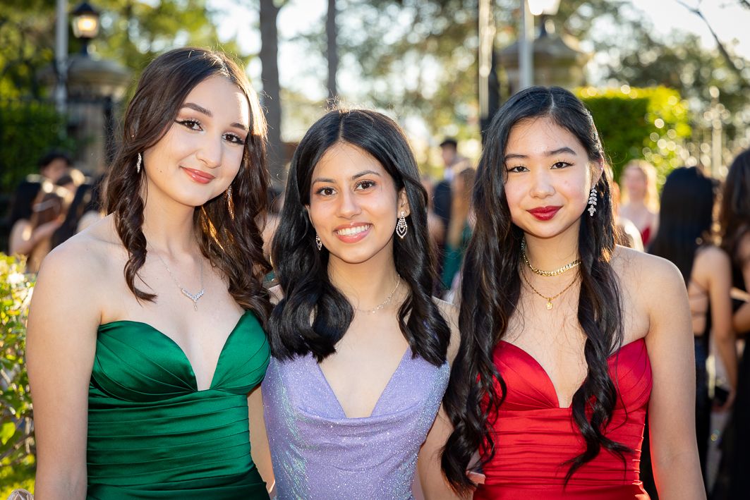 Sydney Event Photography - Three friends in formal dresses pose together at an outdoor evening event.