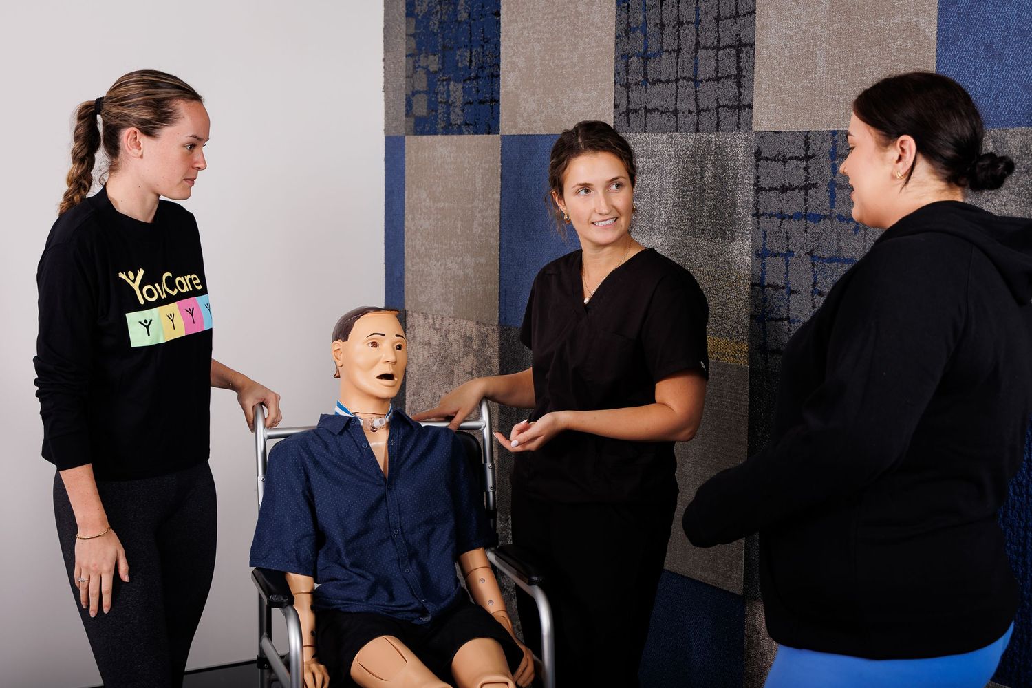 Training demonstration with a medical mannequin in a healthcare education setting.