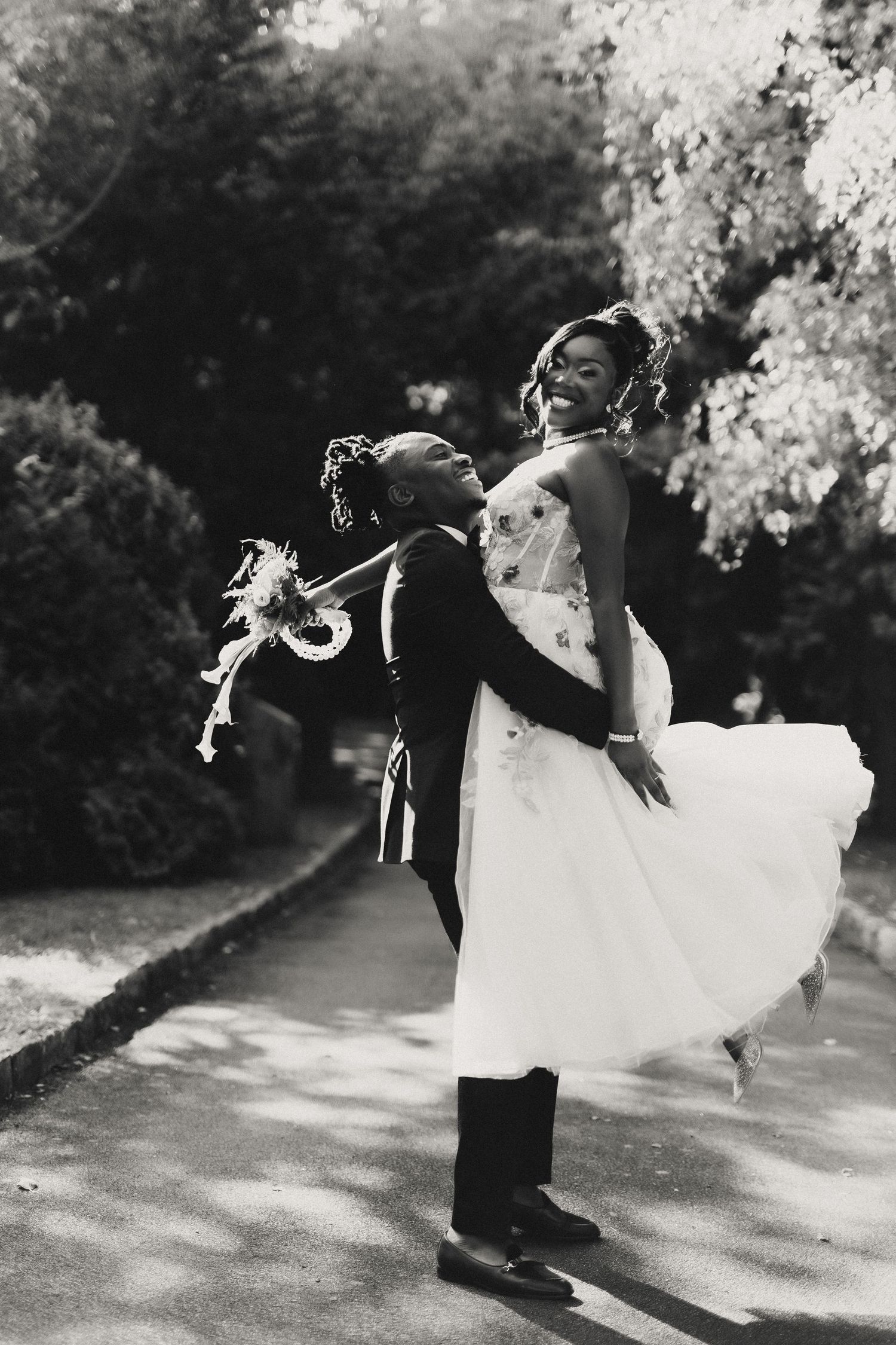 A romantic black and white wedding photo sequence showing a couple in formal attire performing a dip dance move outdoors.