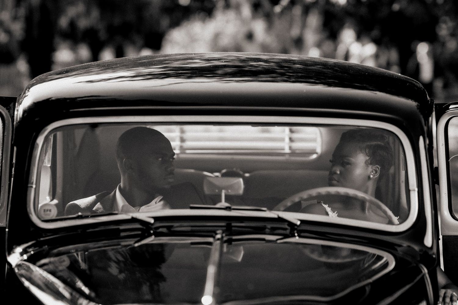 Black silhouettes of vintage car windshields lined up in a row.