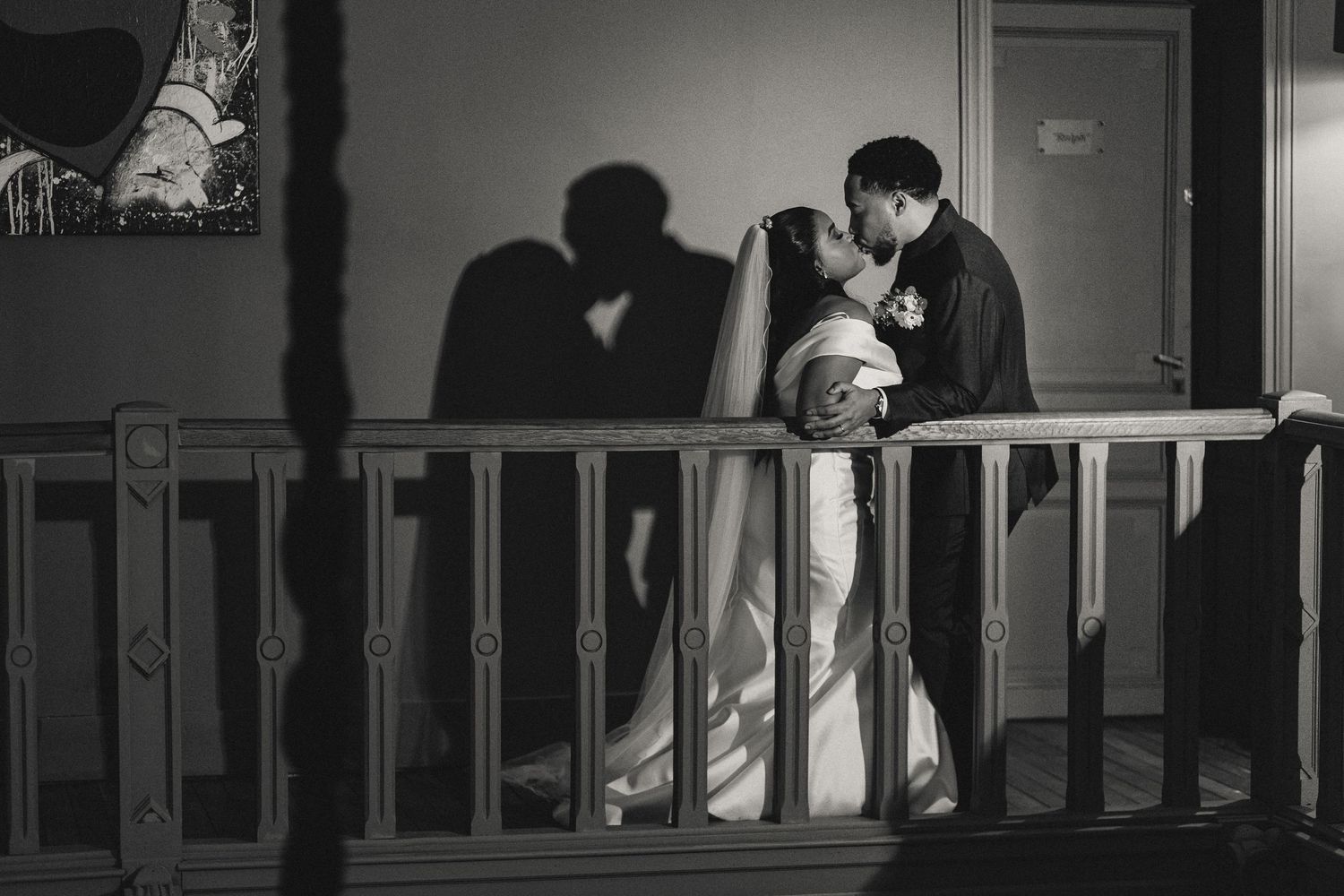 Silhouettes of couples in a dimly lit hallway creating a romantic atmosphere.