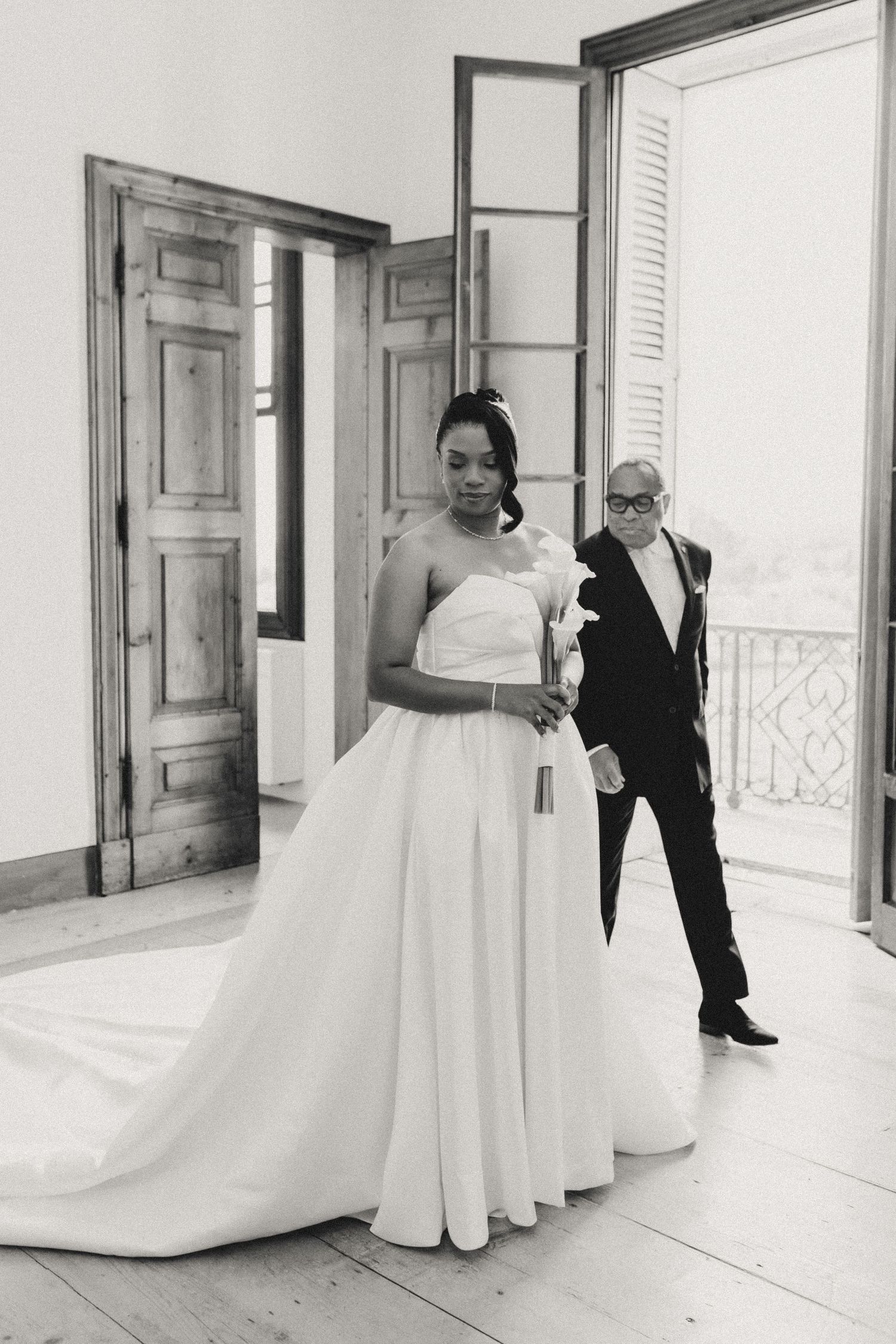 A series of romantic black and white wedding photos showing tender moments between a couple in an elegant indoor setting.