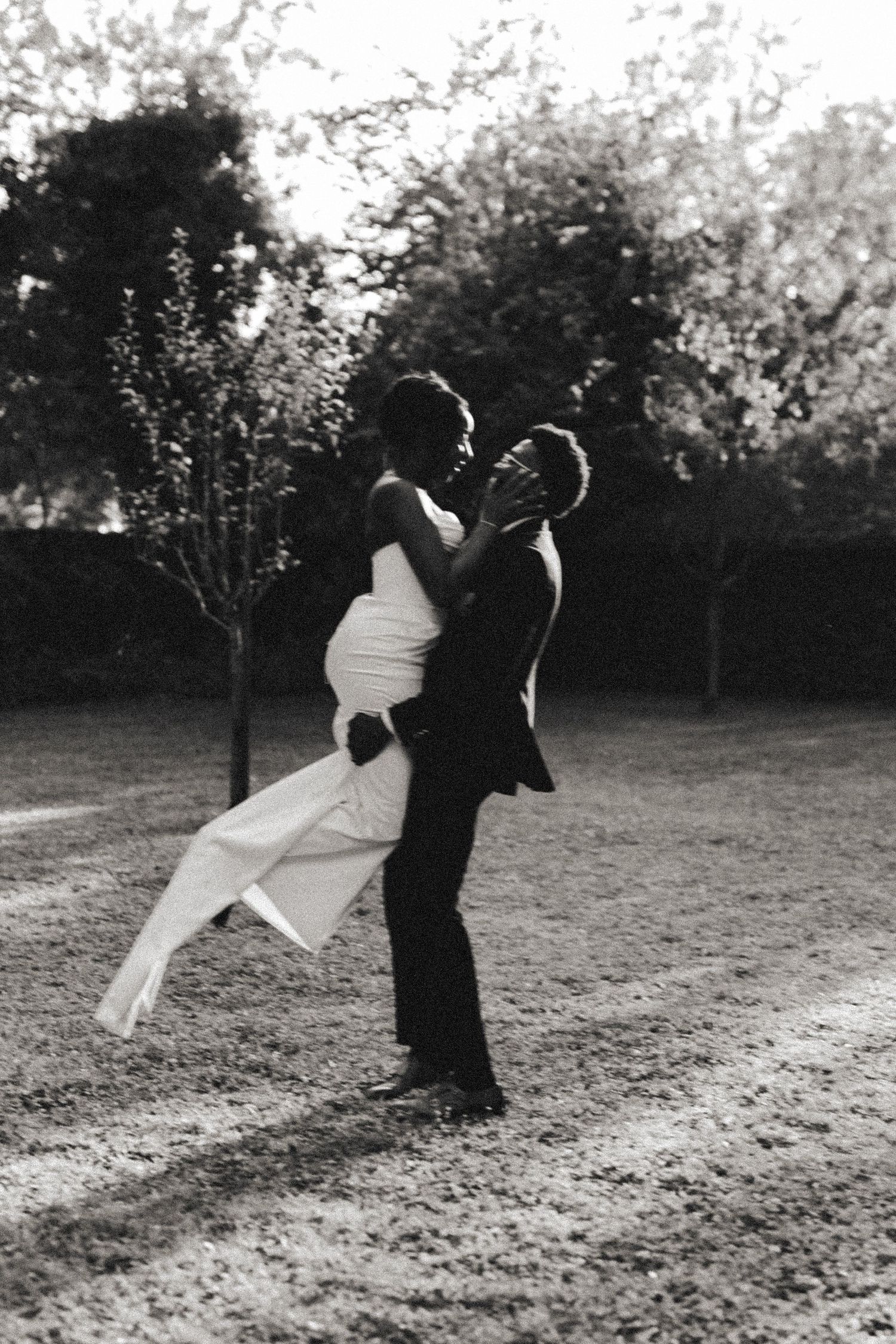 Black and white wedding photos showing couple dancing together in a scenic outdoor setting.