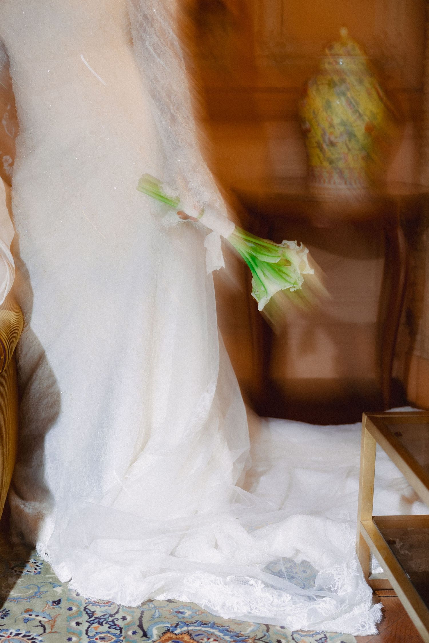 Series of artistic shots showing flowing white wedding dress details with subtle green accents.