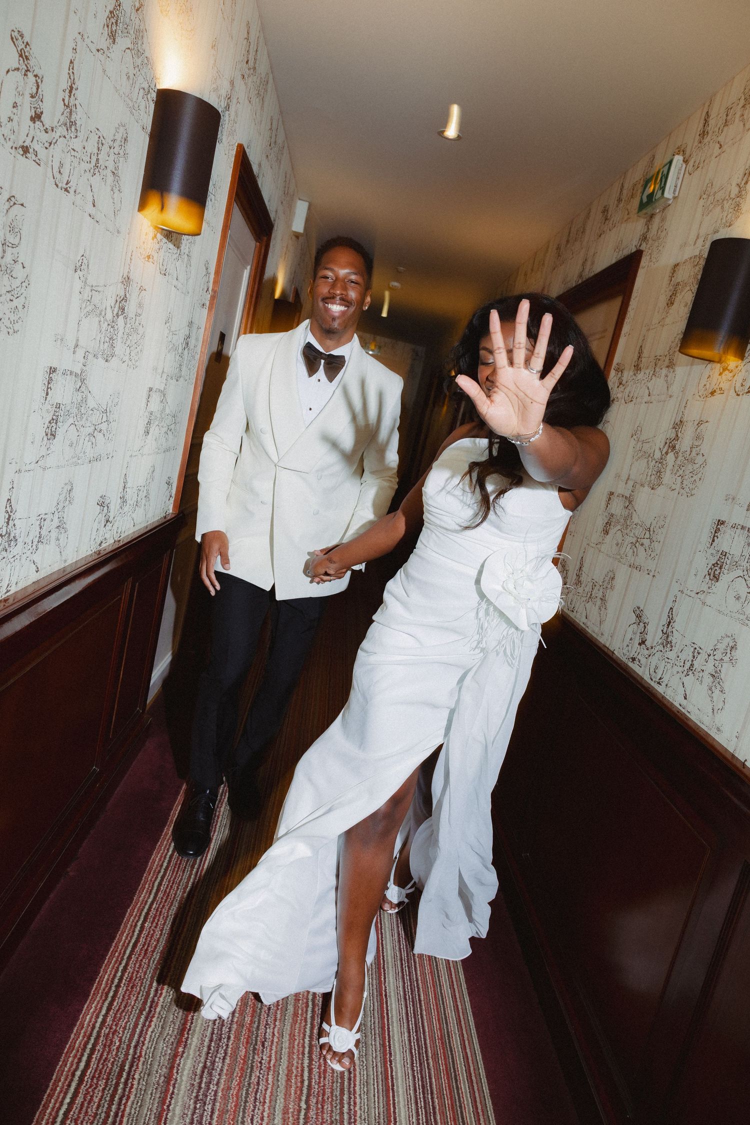 A sequence of photos shows a person in white clothing dancing and posing playfully in a hotel hallway.