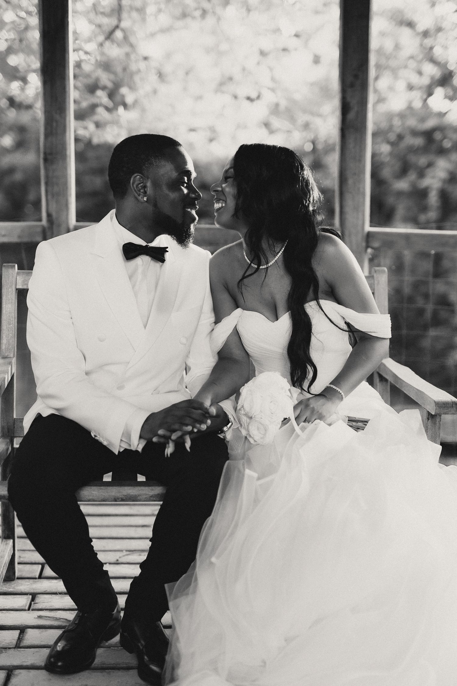 Black and white sequence of newlyweds sharing tender moments in an outdoor gazebo.