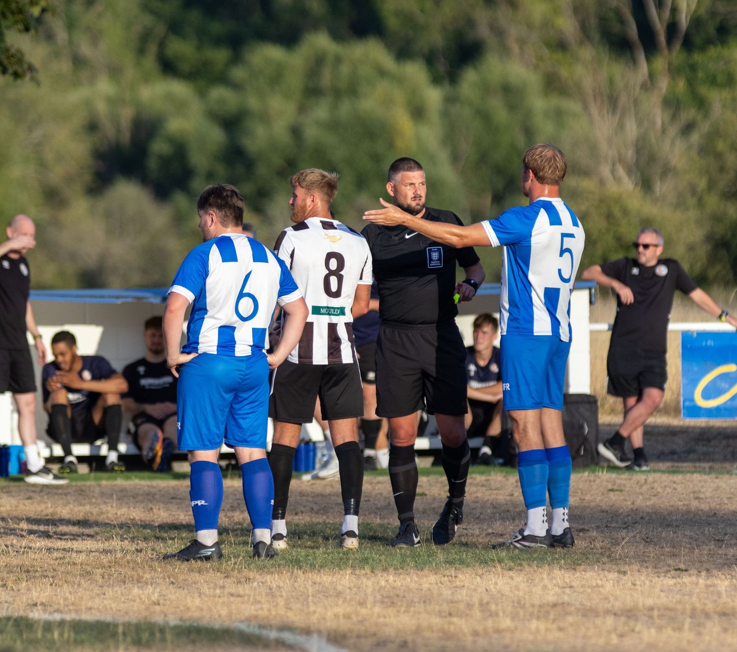 Amesbury town fc player and Bemerton heath harlequins fc player arguing with ref
