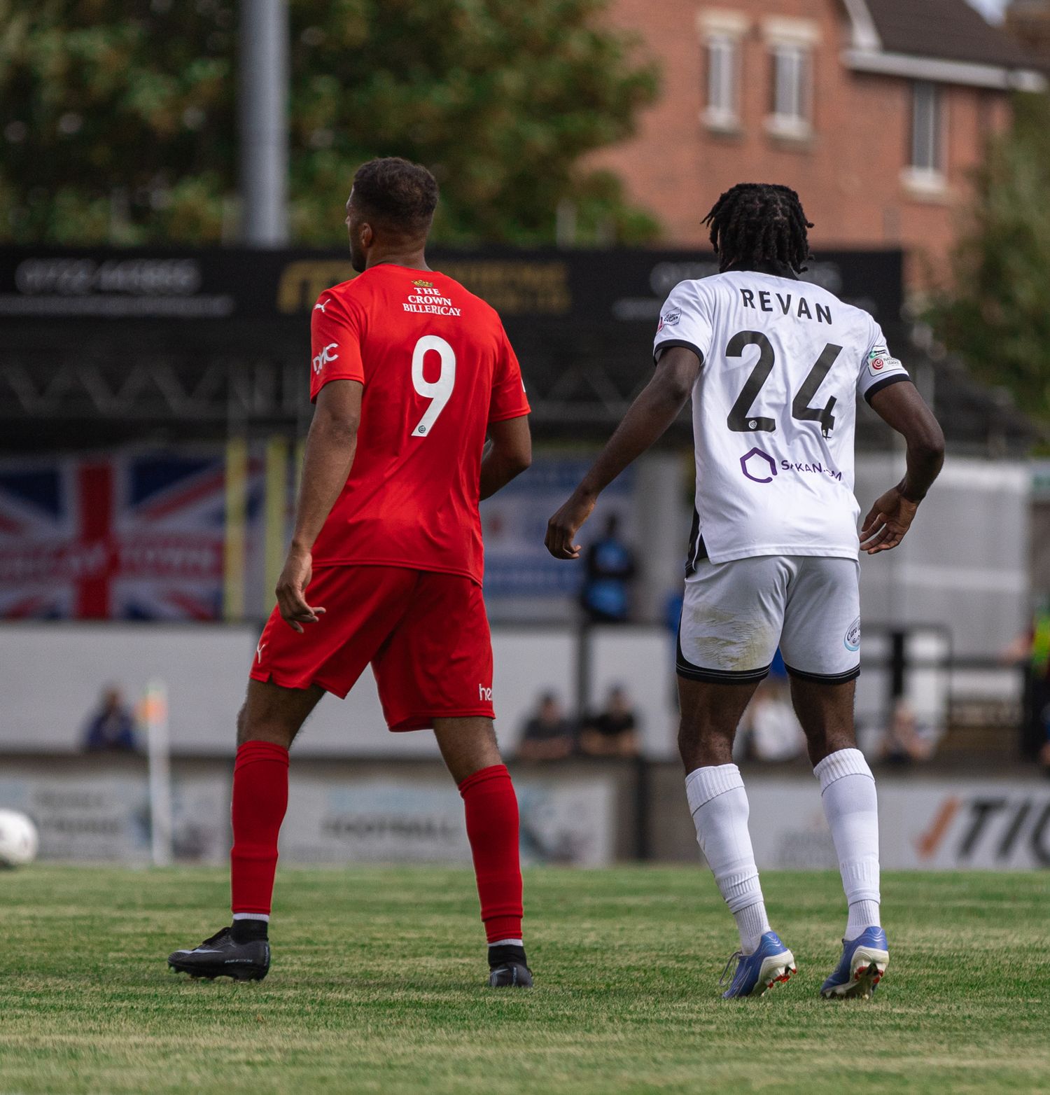 Two soccer players on a green field, one in red jersey number 9, another in white jersey number 24 named Revan.