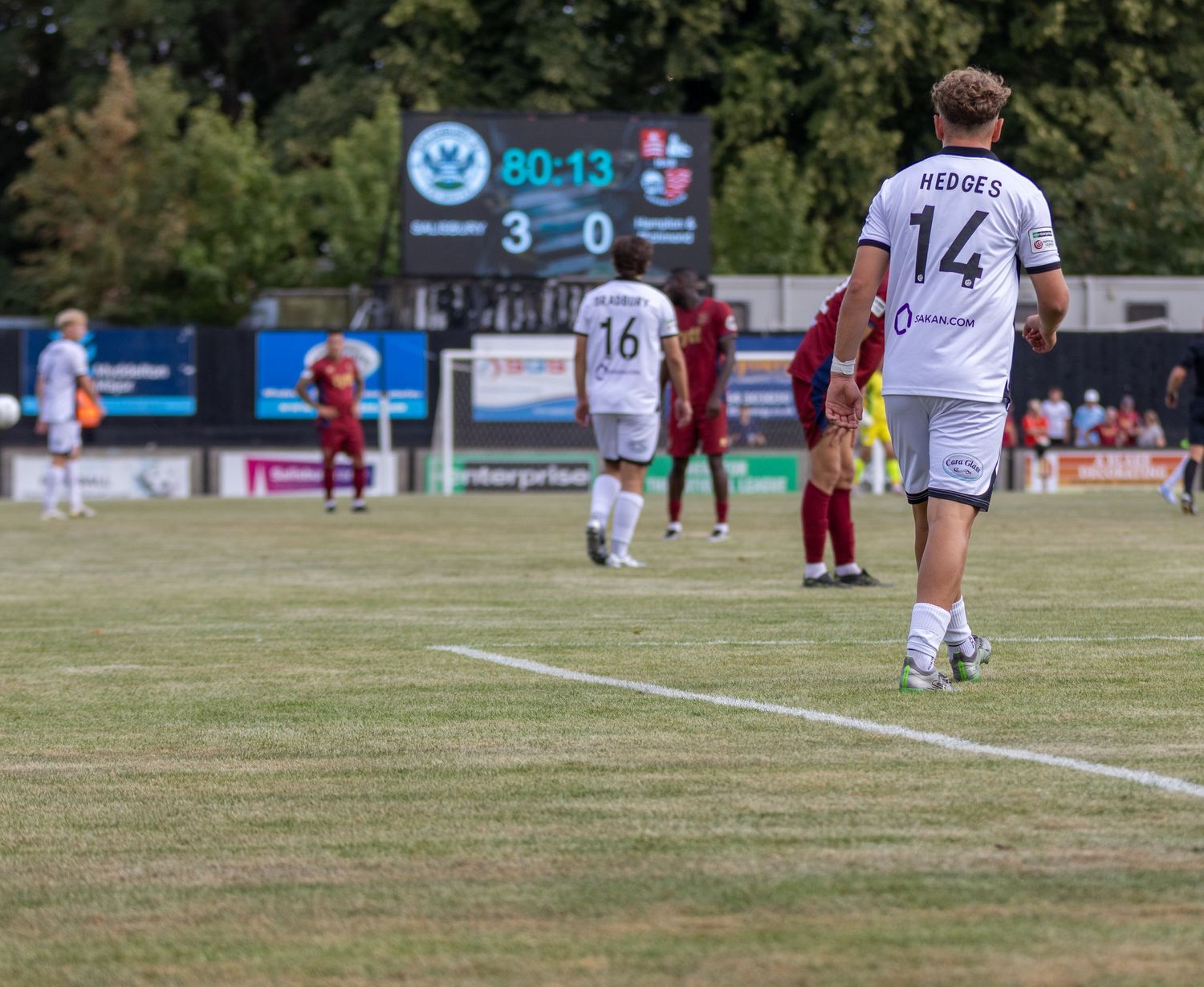 Player number 14 HEDGES walks near touchline with scoreboard showing 3-0 at 80 minutes during a match.