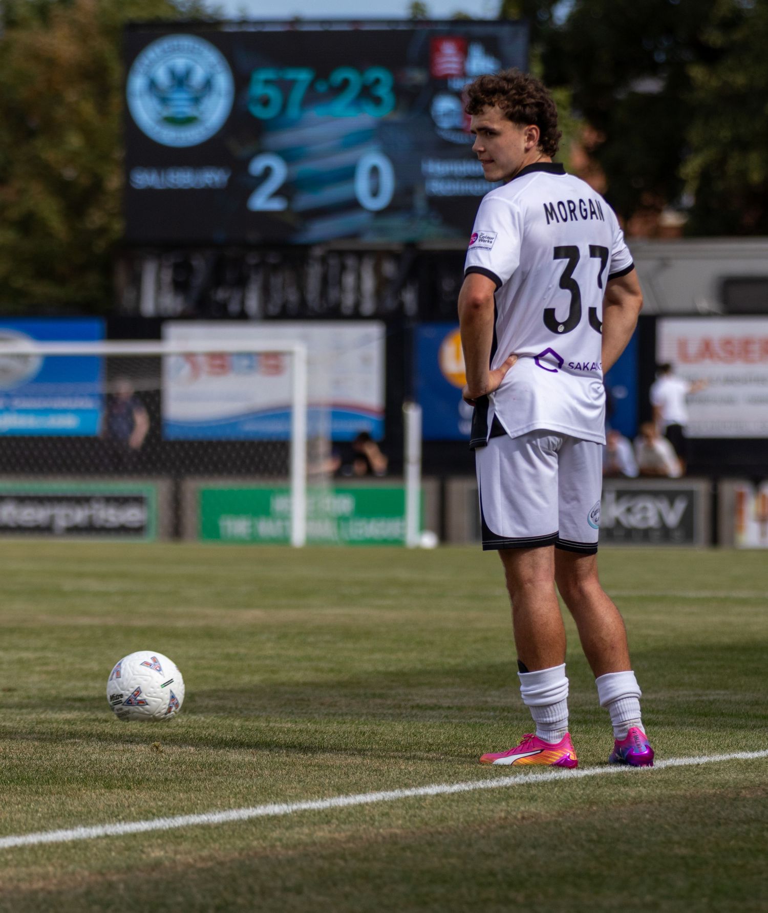 Footballer Morgan wearing number 33 stands over a ball with a 2-0 scoreboard visible behind him.