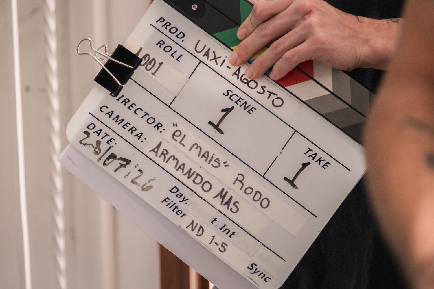 Close-up of movie clapperboard showing production details on film set.