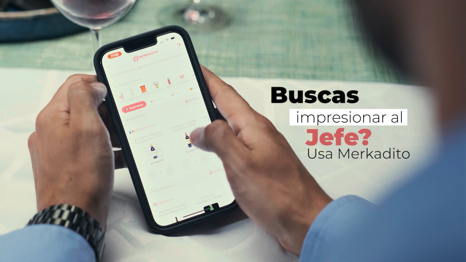 Person holding smartphone displaying Merkadito app with text Buscas impresionar al Jefe.