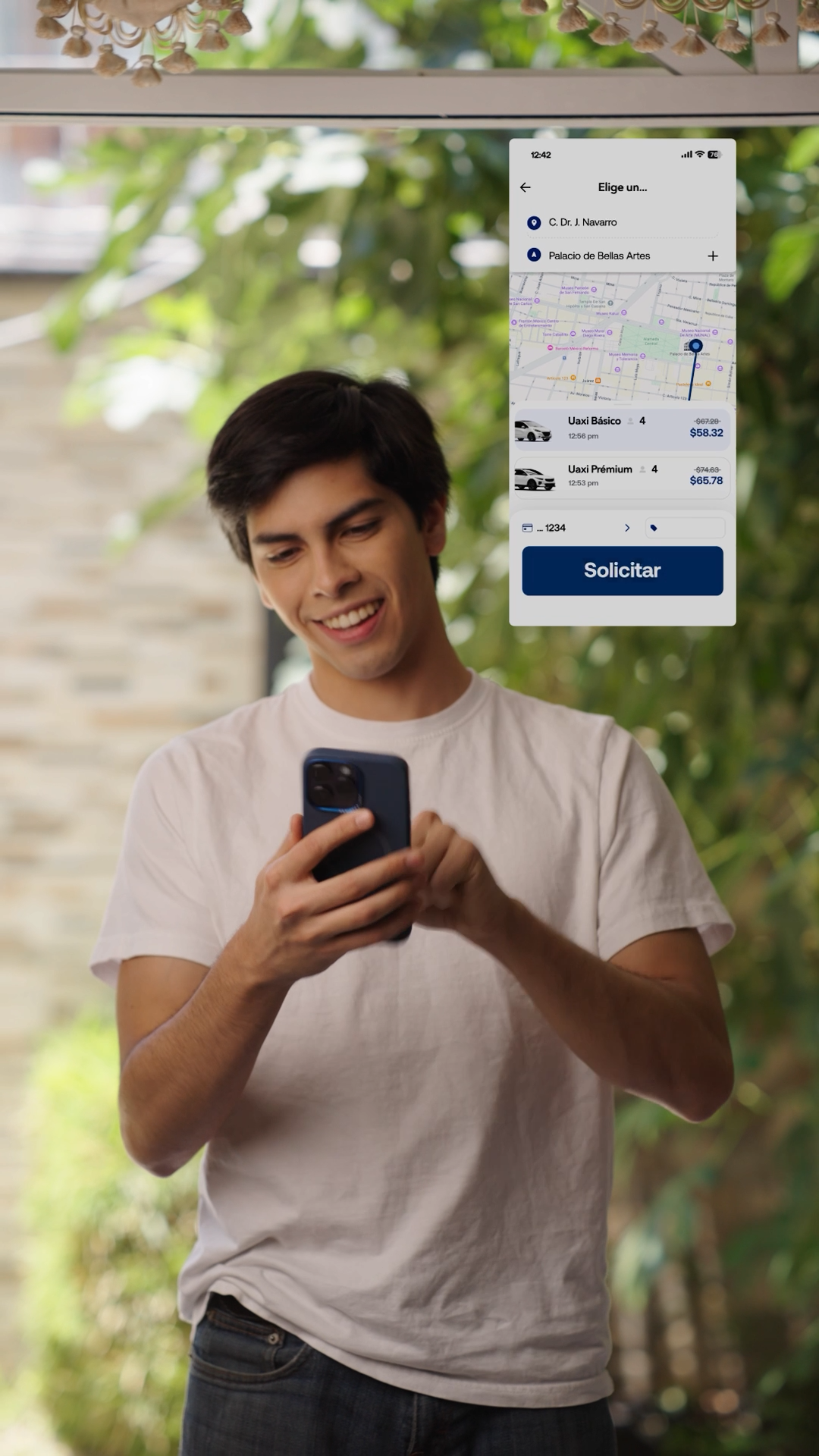 Young man smiling at his phone with UAXI ride-sharing app interface displayed above him.