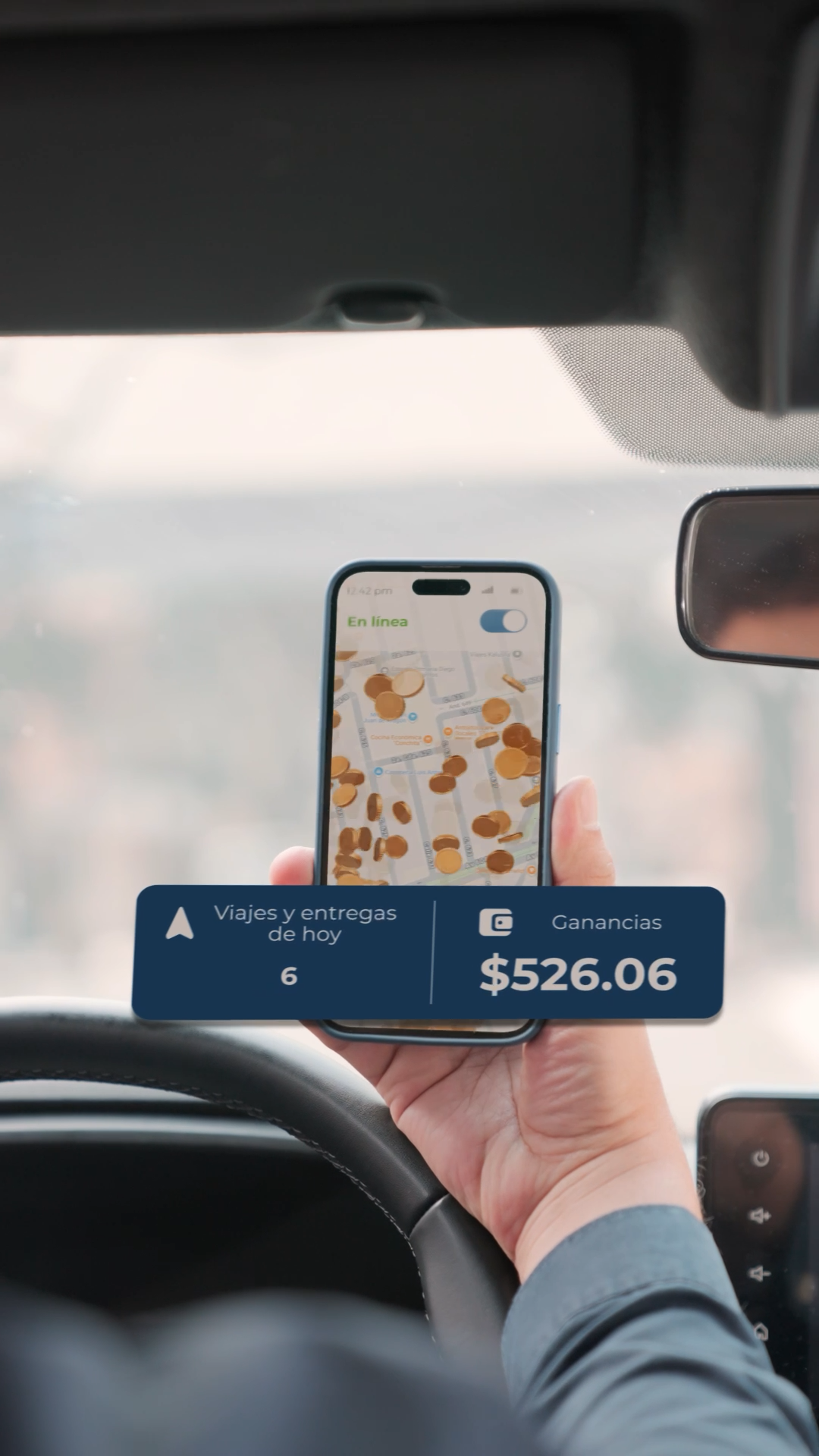 Driver holding a smartphone showing UAXI ride-sharing app with earnings of $526.06.