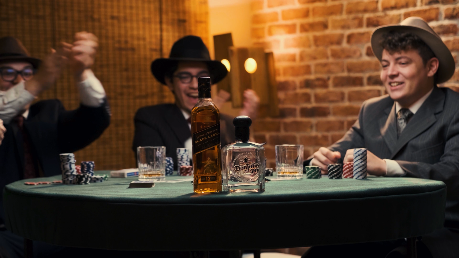 Group of men in vintage hats laughing at a poker table with Johnnie Walker whiskey bottle.