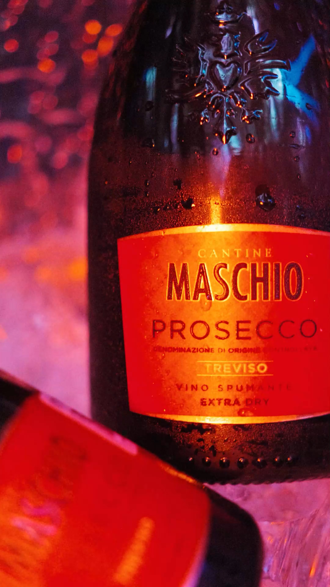 Close-up of a chilled Cantine Maschio Prosecco Treviso Extra Dry bottle with condensation droplets.
