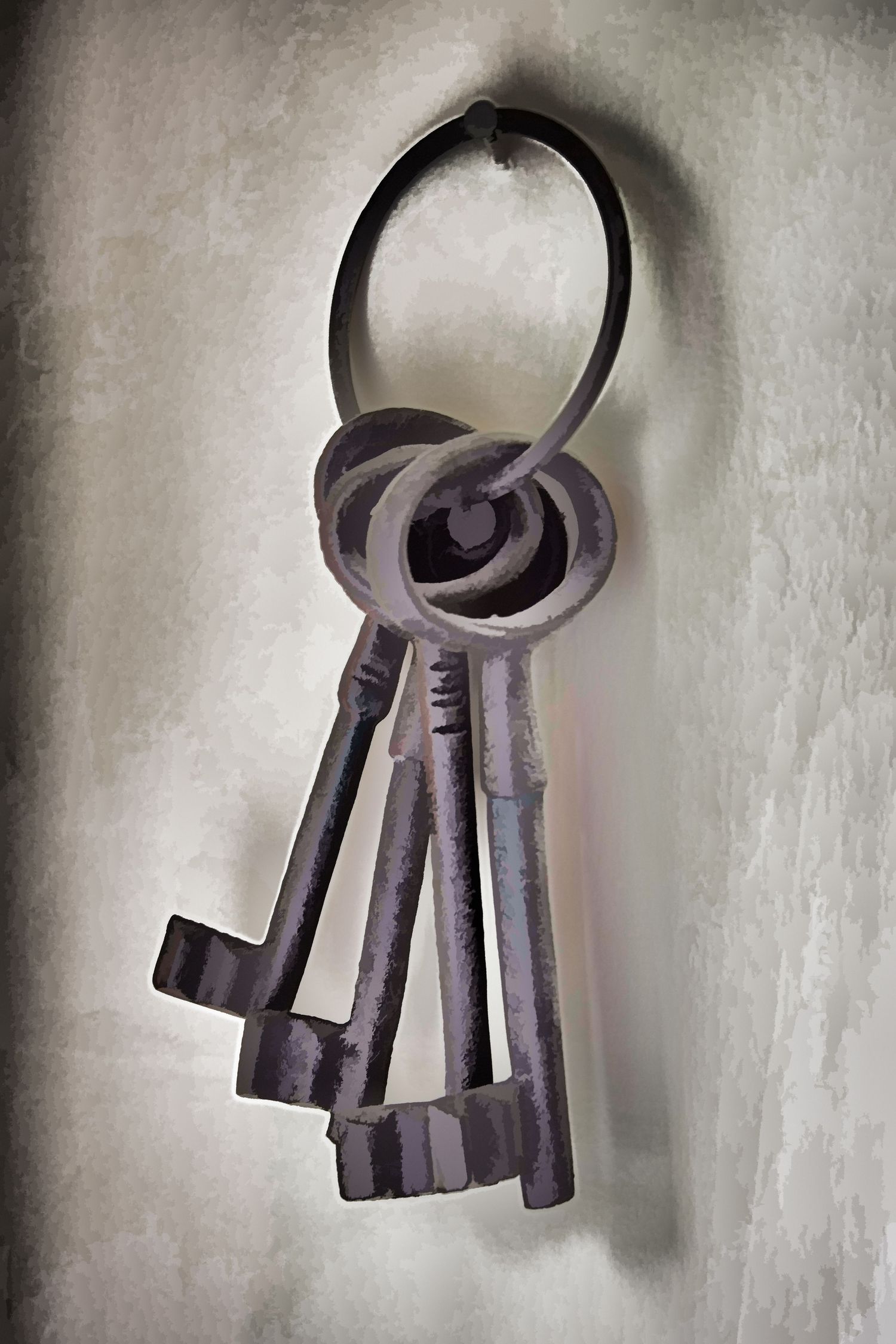 Vintage bunch of old skeleton keys hanging on a metal ring against a gray textured background.