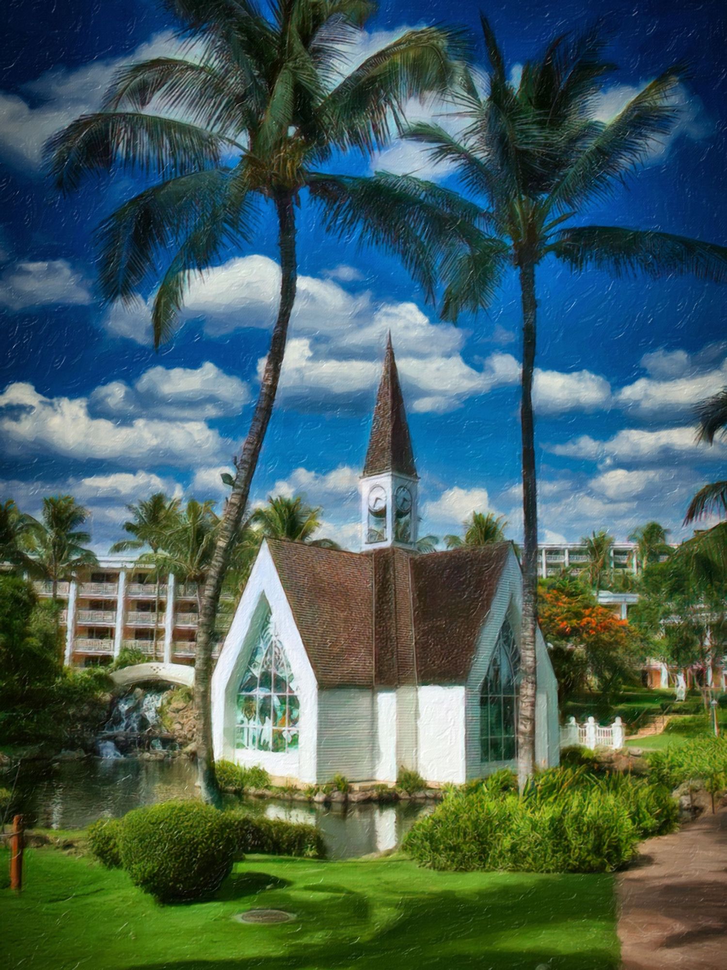 Charming white chapel with steeple surrounded by tall palm trees under a blue sky in Hawaii.