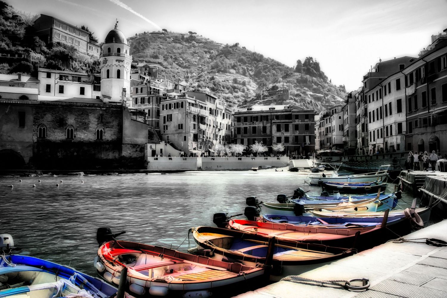 Colorful rowboats docked in a harbor at Vernazza, Cinque Terre, Italy, in selective color photography.