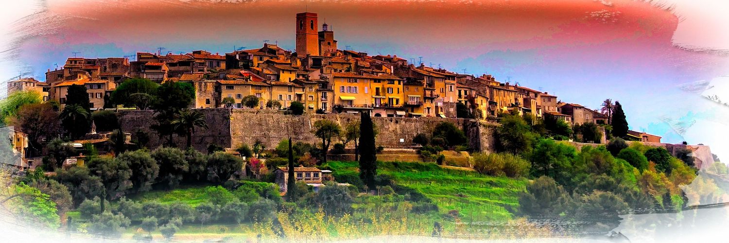 Panoramic view of a medieval hilltop village in the South of France at sunset.