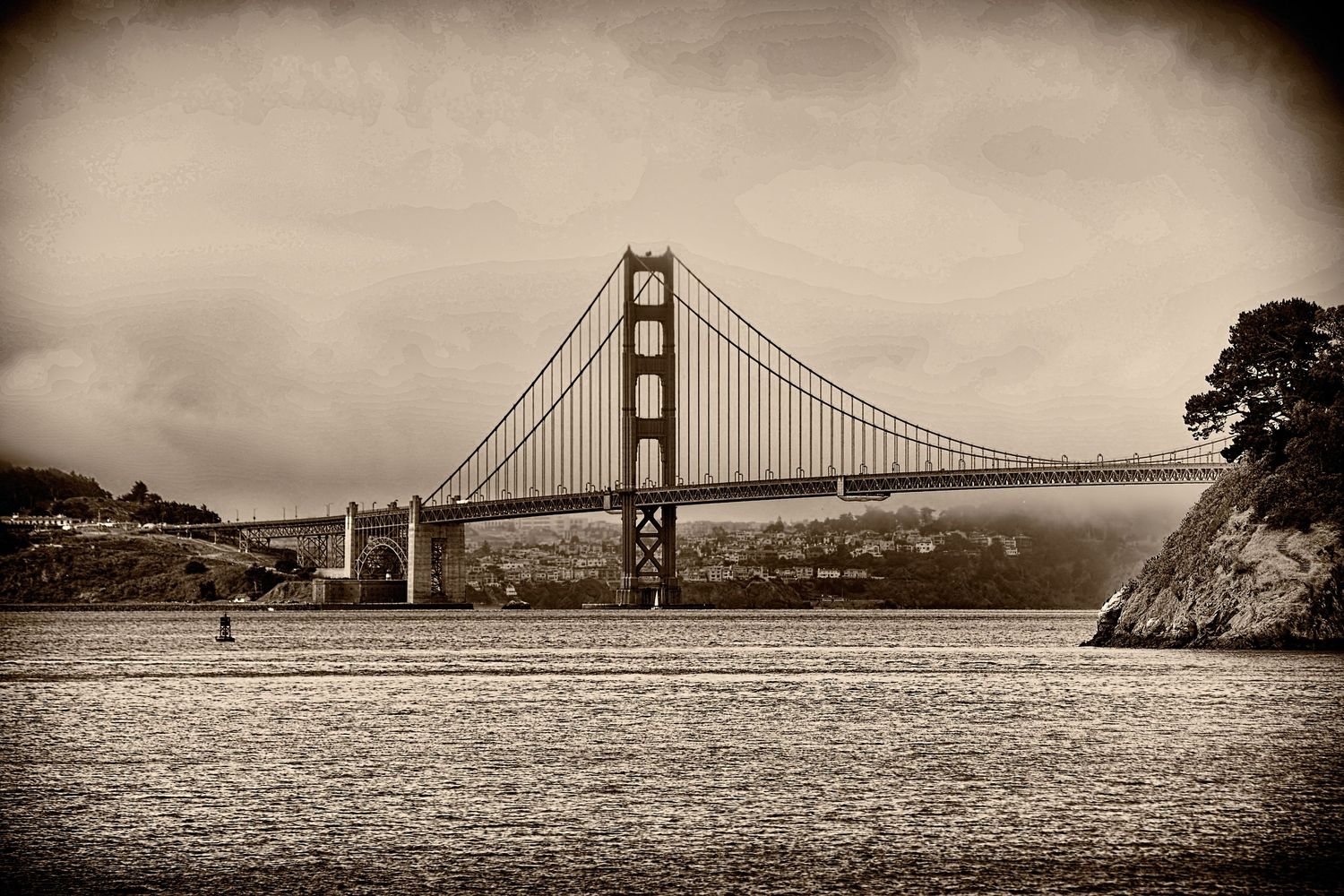 Vintage sepia-toned photograph of the Golden Gate Bridge spanning San Francisco Bay under an overcast sky.