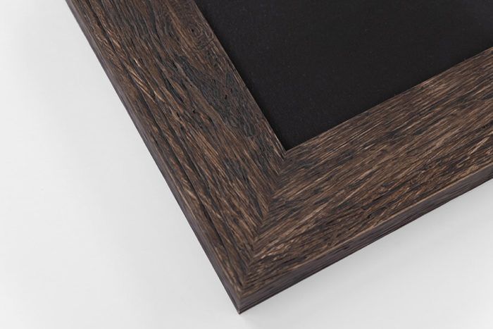 Dark brown rustic wood picture frame corner with black chalkboard surface on white background.