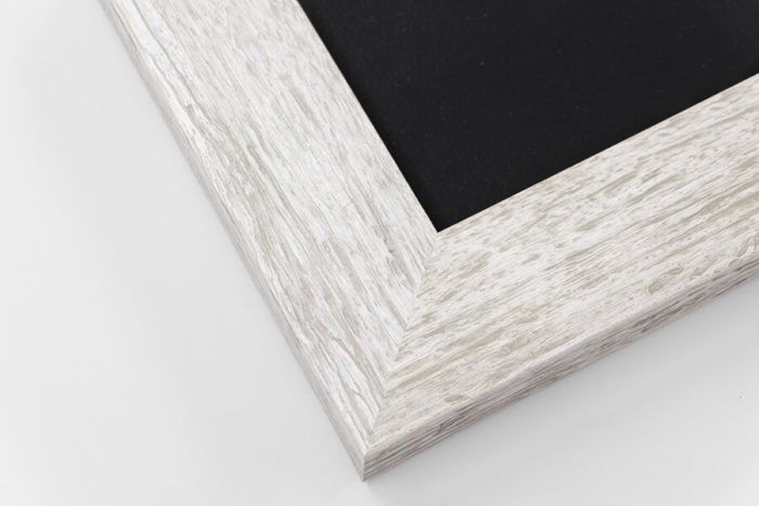 White distressed rustic wood picture frame corner with black chalkboard surface on white background.