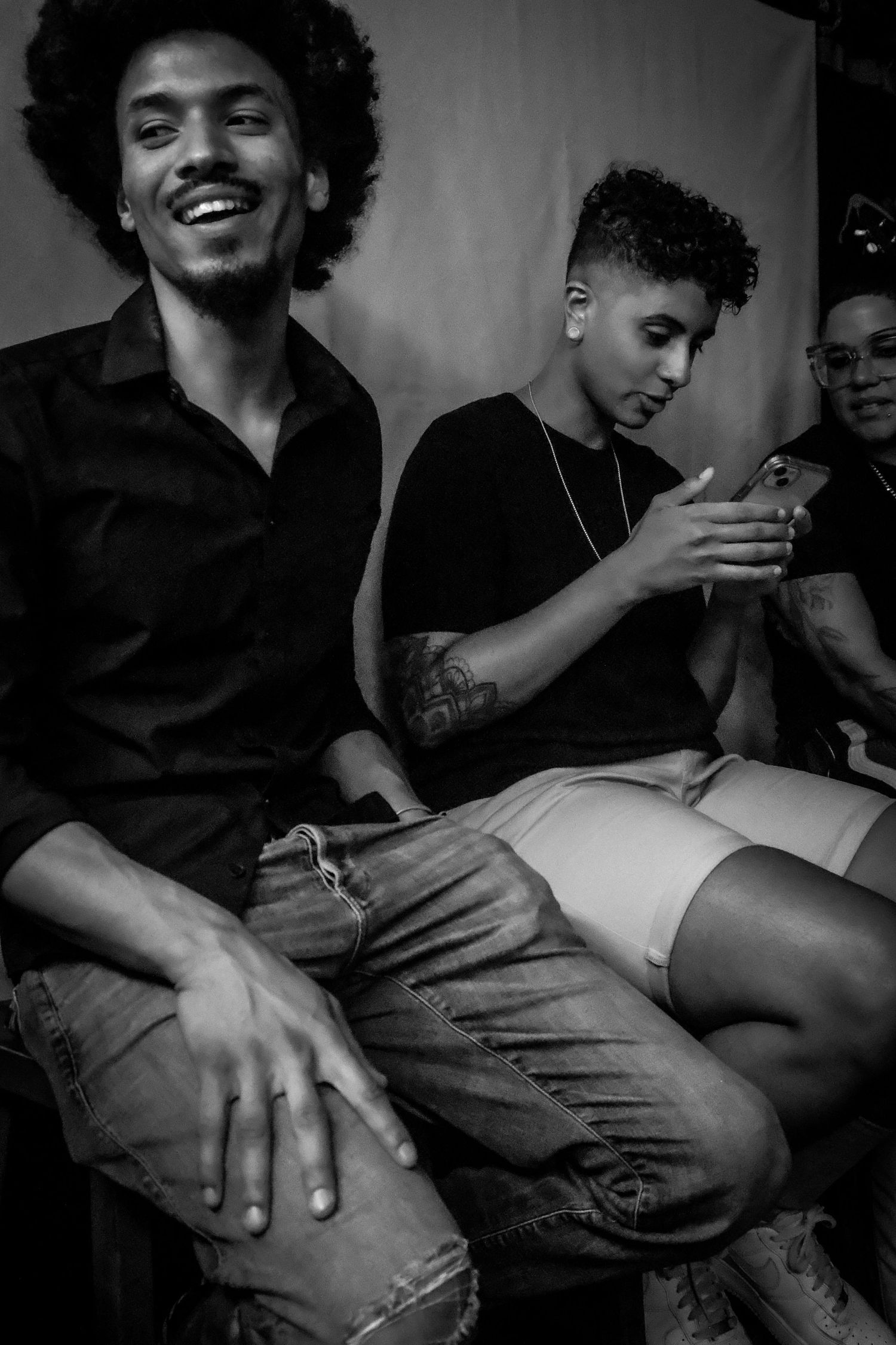 Group of young men relaxing and socializing at a music venue in black and white.