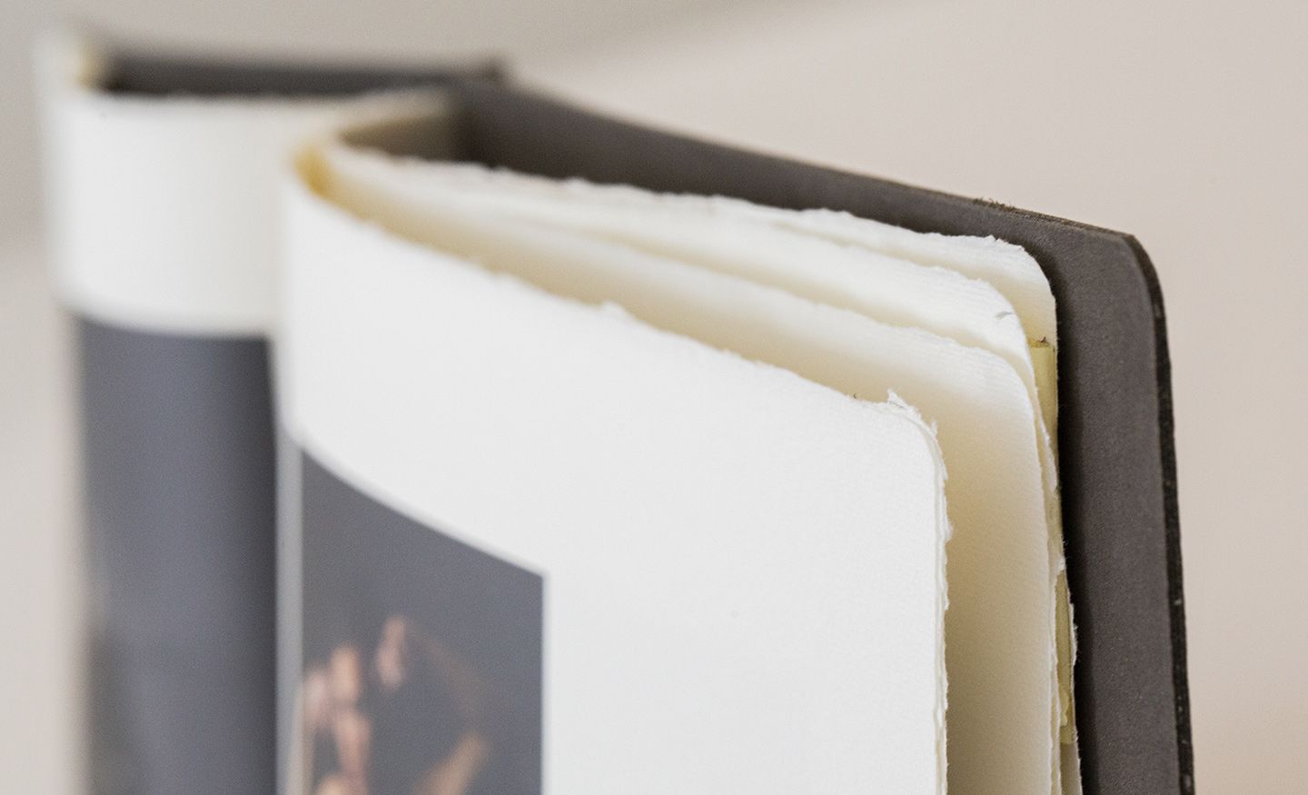 Close-up view of white pages in a hardcover book showing the binding detail and page edges.