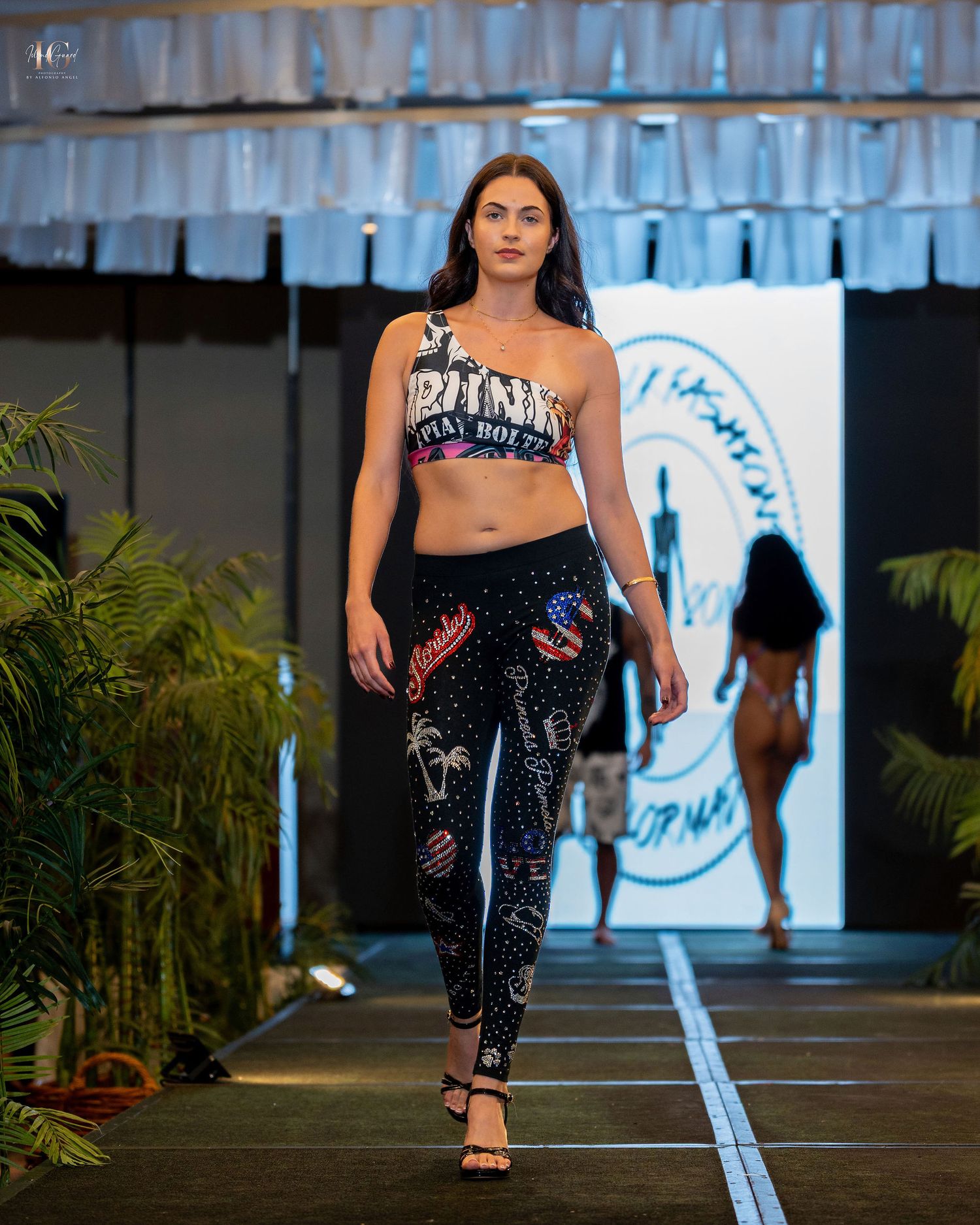 Models walk the runway wearing athletic apparel and activewear during a fashion show presentation.