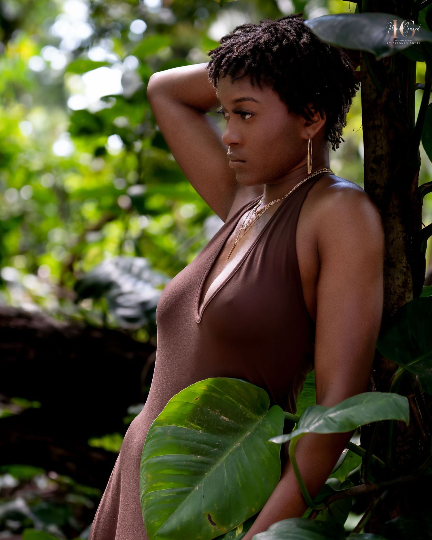 Child explores natural surroundings in lush jungle setting with tropical foliage in soft natural lighting.