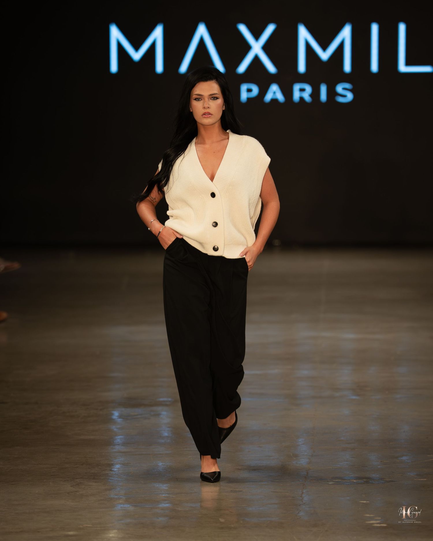 Model walks runway in black and white outfit during Max Mili Paris fashion show.