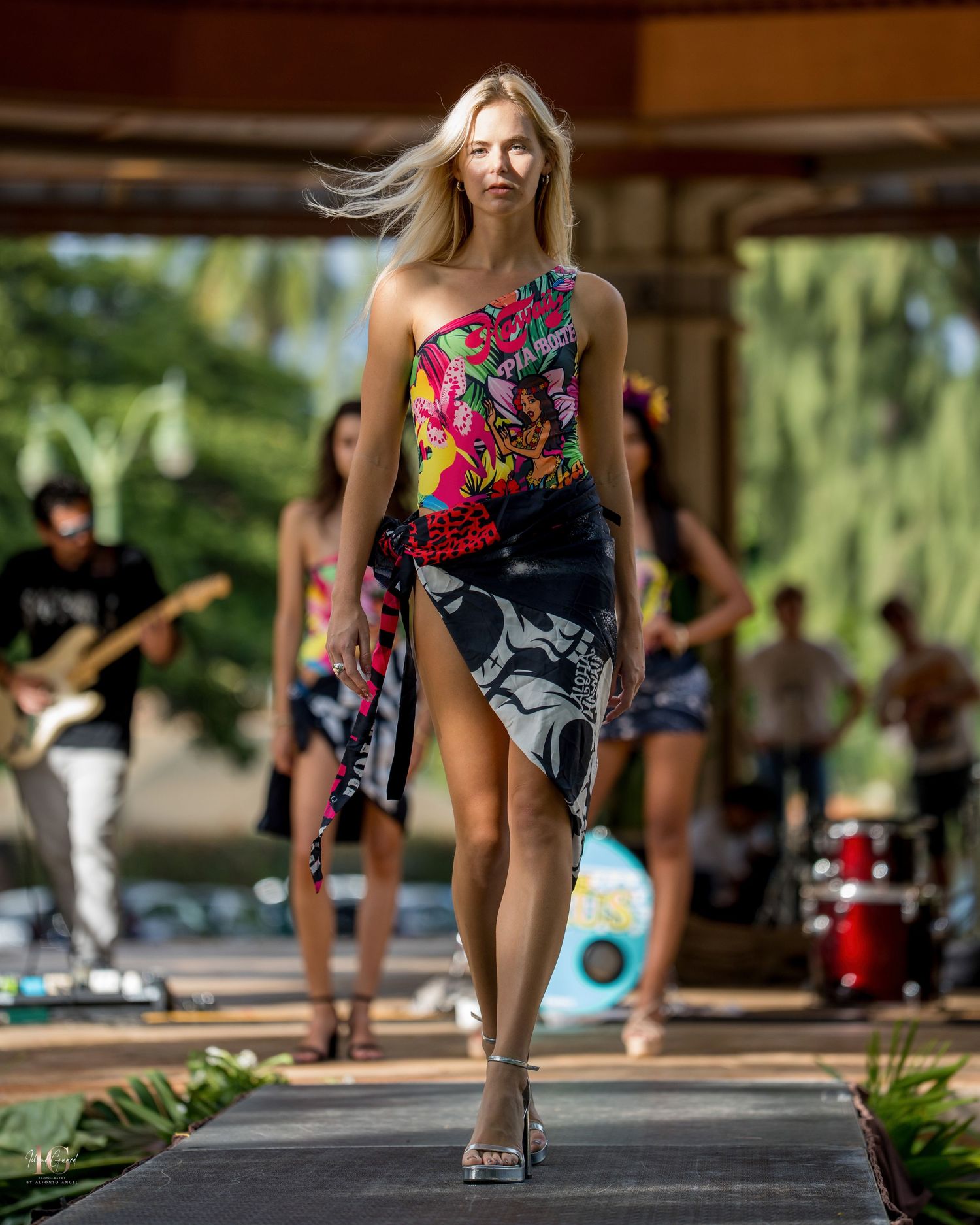 Athletic person in colorful workout attire performs burpee exercise sequence on outdoor platform.