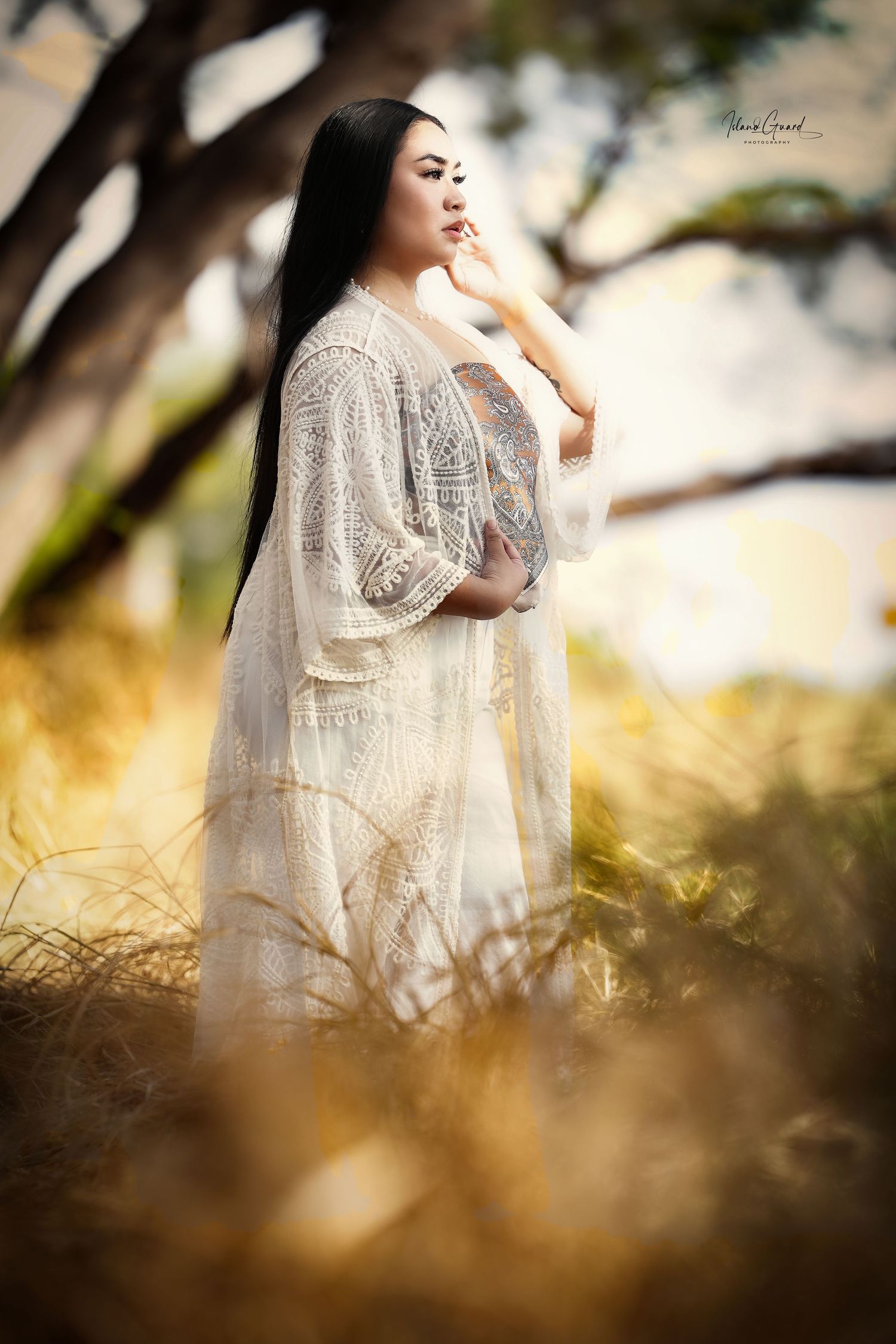A soft dreamy portrait series in a field showing a figure in a white lace dress against golden grasses at sunset.