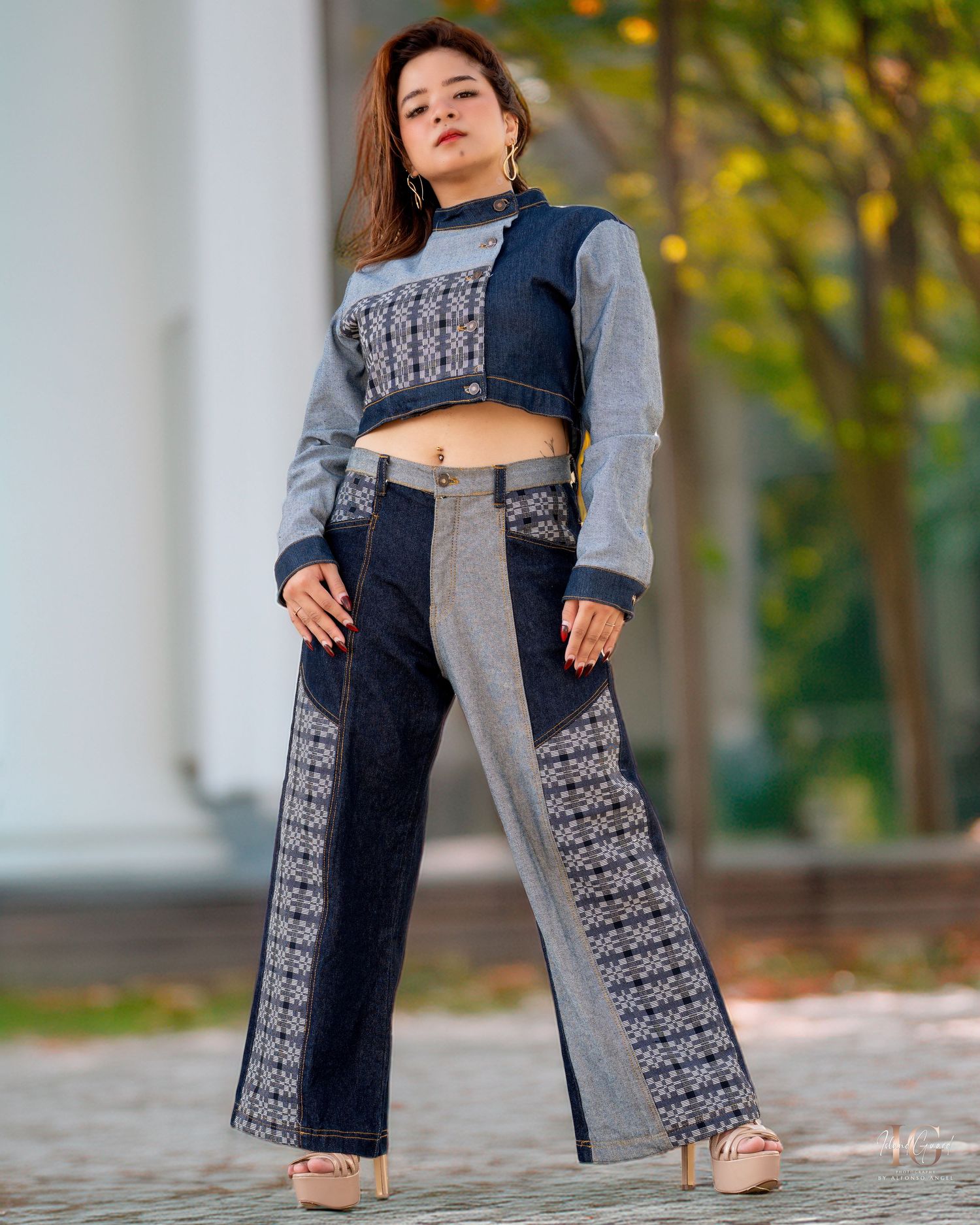 A pair of navy and grey patterned Palazzo pants shown from different angles against a blurred garden background.