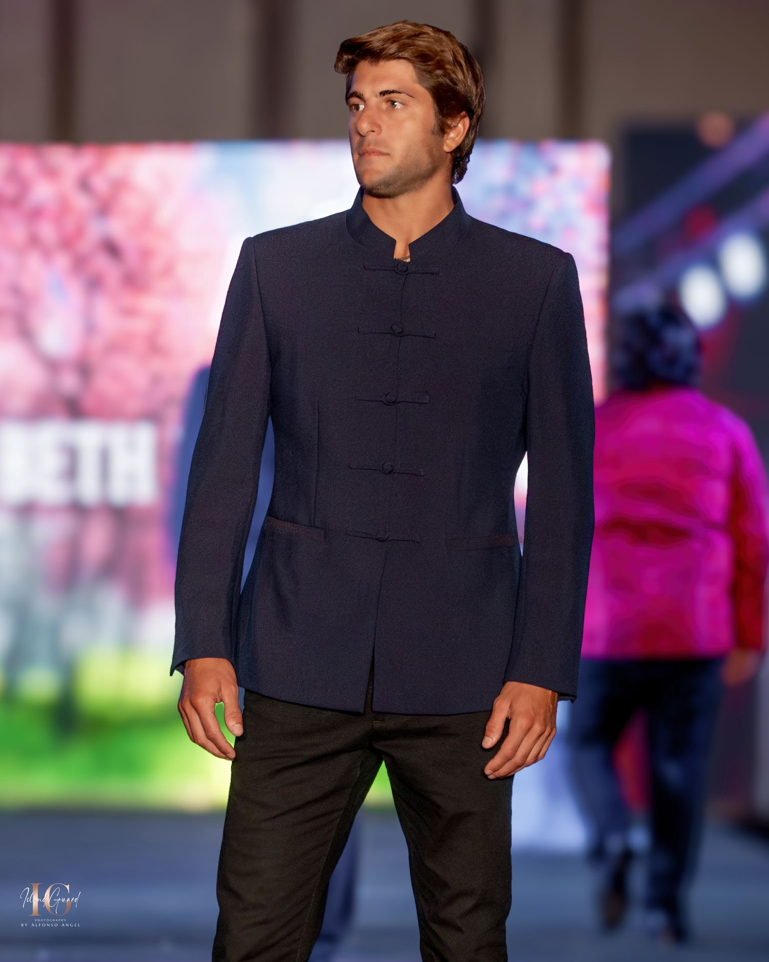 Minimalist navy blue men's formal wear displayed on fashion runway.