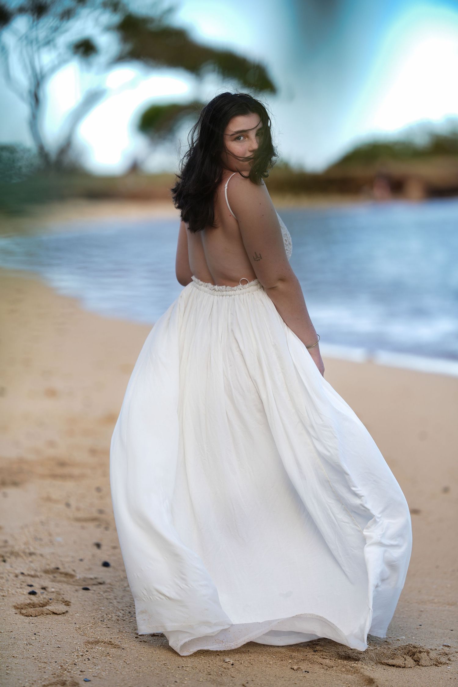 A series of aesthetic beach photos showing a flowing white dress against sandy shores and blue waters.