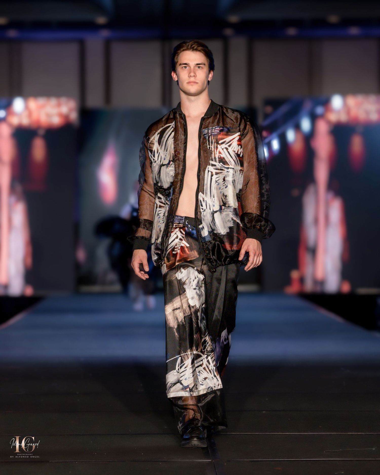 Edgy metallic print jacket and pants ensemble worn with bare chest on modern runway.