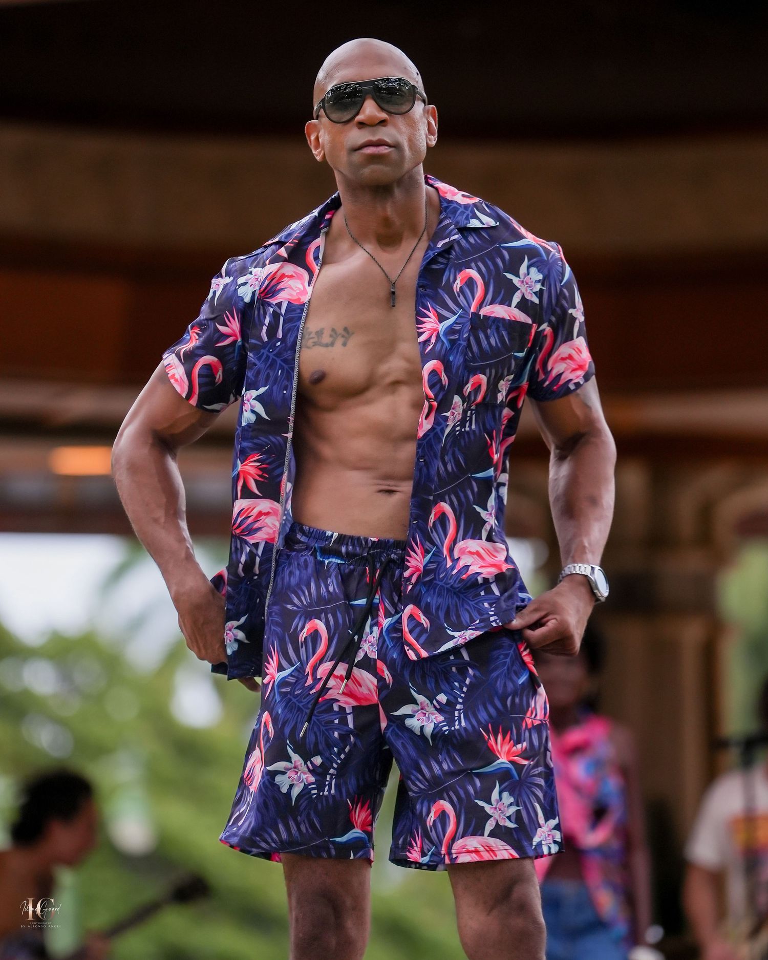 A person wearing sunglasses and a colorful floral Hawaiian shirt poses outdoors in multiple similar shots.