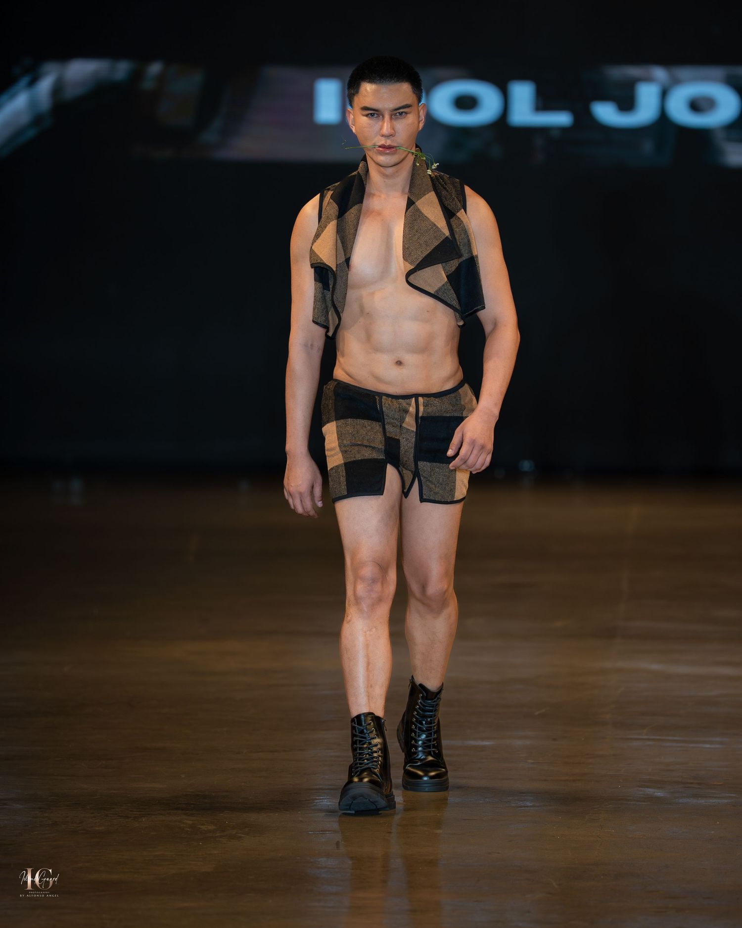 Models walk the runway in black underwear and mesh tops during a fashion show presentation.