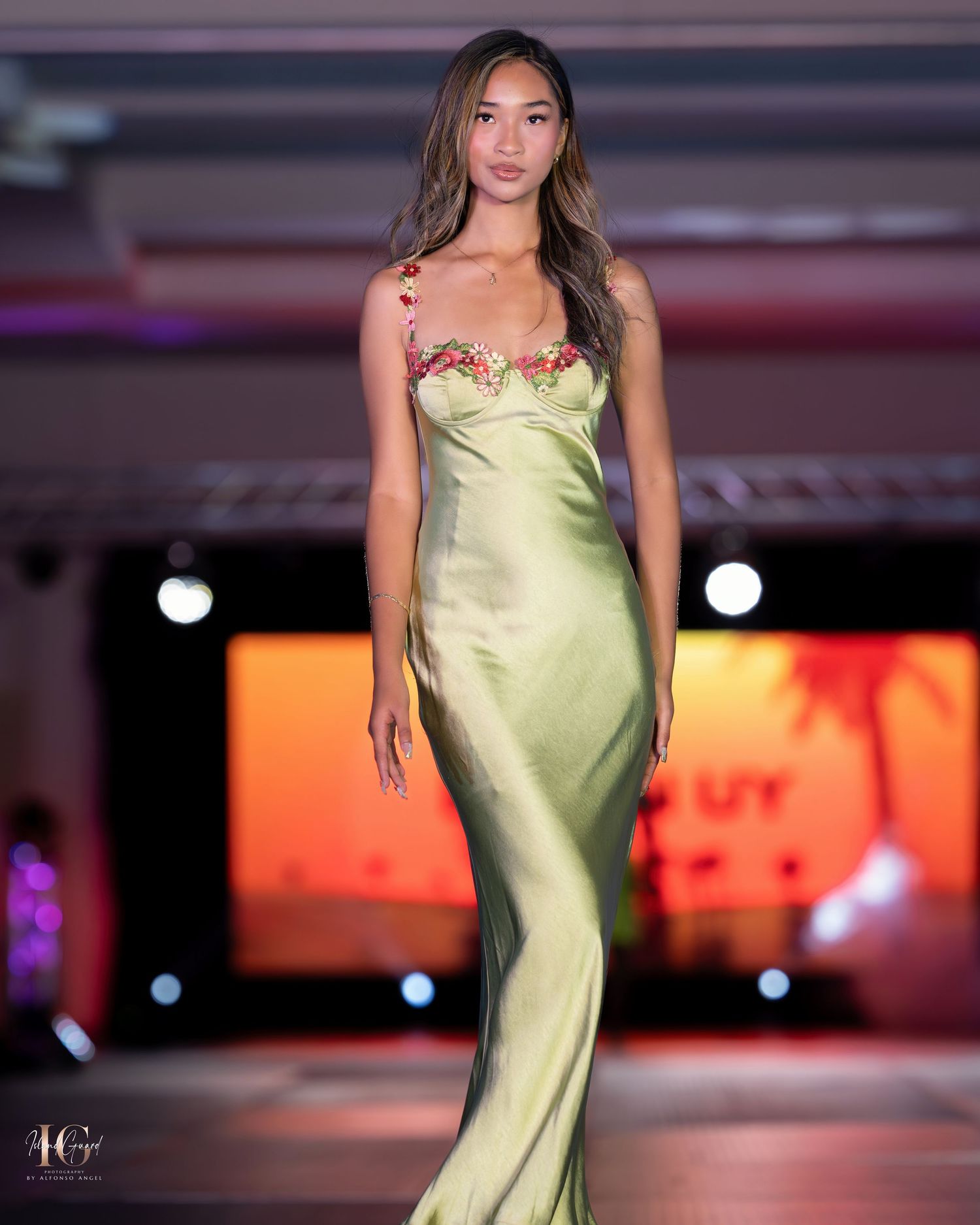 Elegant silk champagne slip dress with delicate strap details shown on fashion runway.