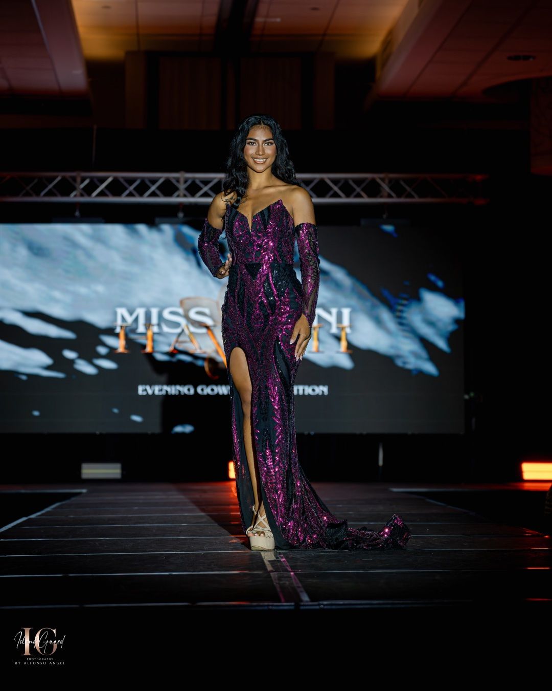A contestant walks the runway in a stunning purple sequined evening gown during a Miss Utah pageant competition.