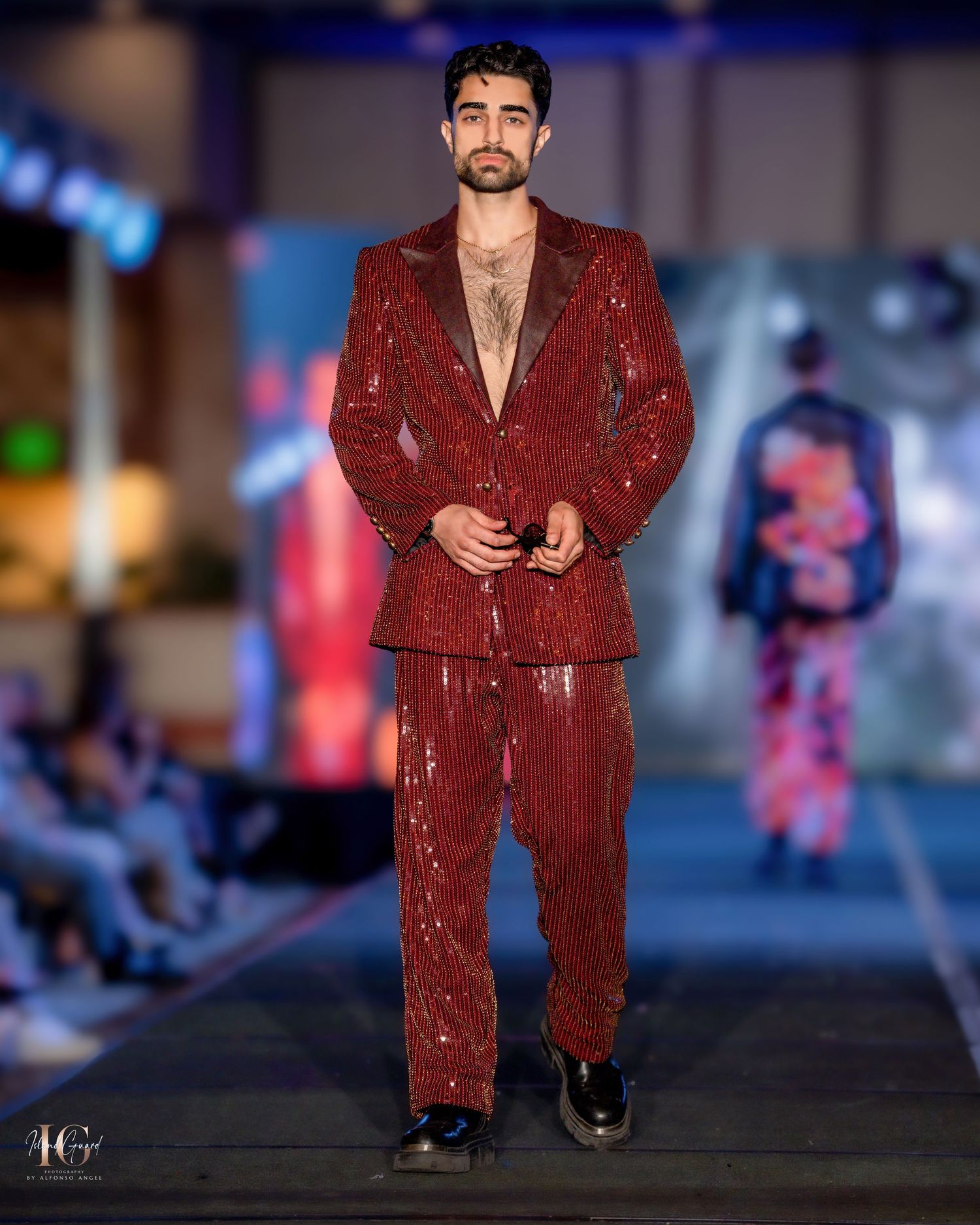 Deep red sequined suit ensemble presented during evening fashion show.