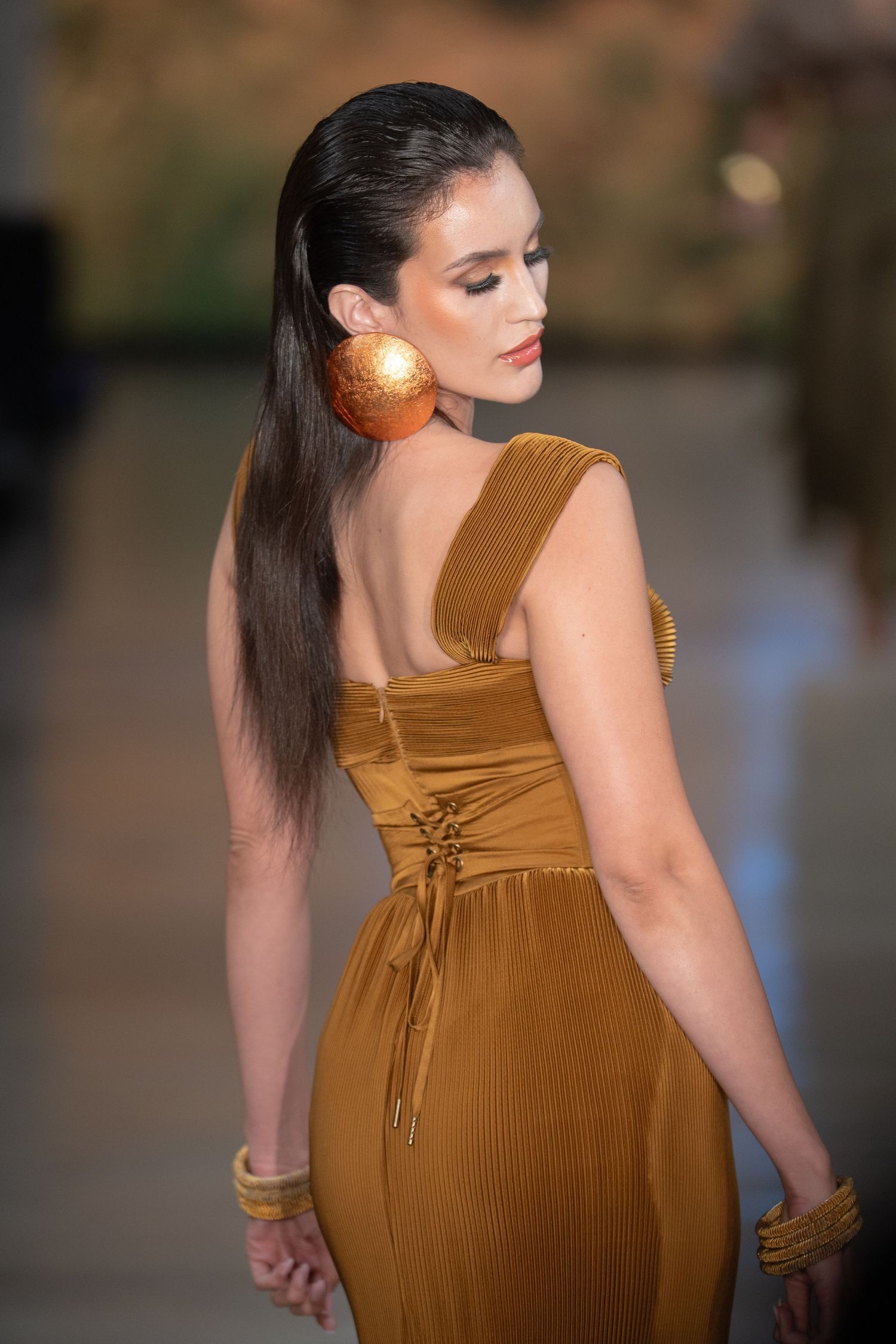 A series of fashion photos showing a brown ribbed dress with lace-up back detail from multiple angles.